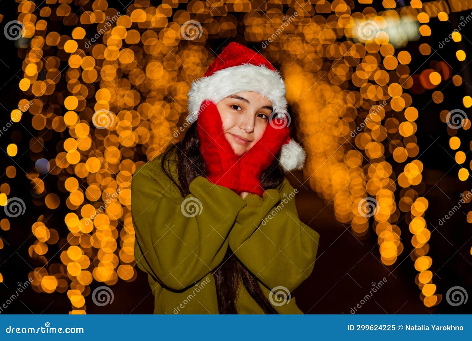 A Young, Beautiful Girl Walks in a Santa Hat, in the Evening City ...