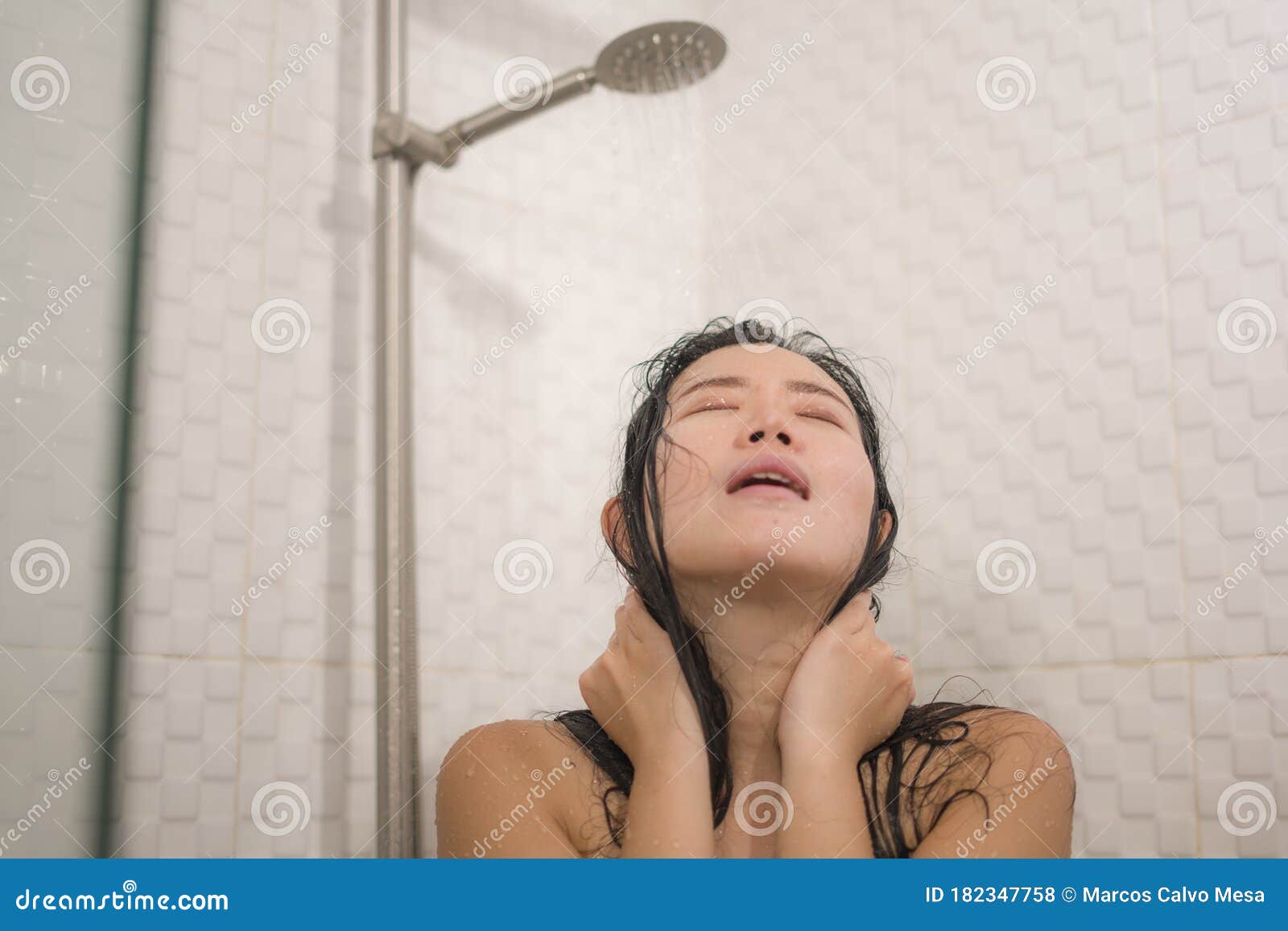 Young Beautiful And Happy Asian Chinese Woman Taking A Shower In The