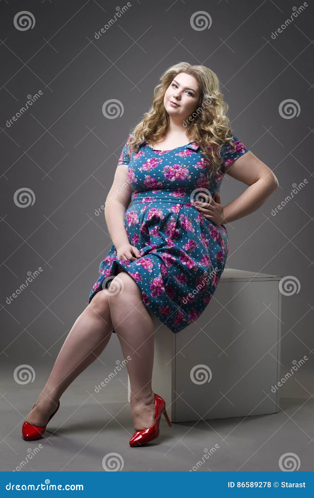 Young Beautiful Happy Blonde Plus Size Model in Dress and Shoes