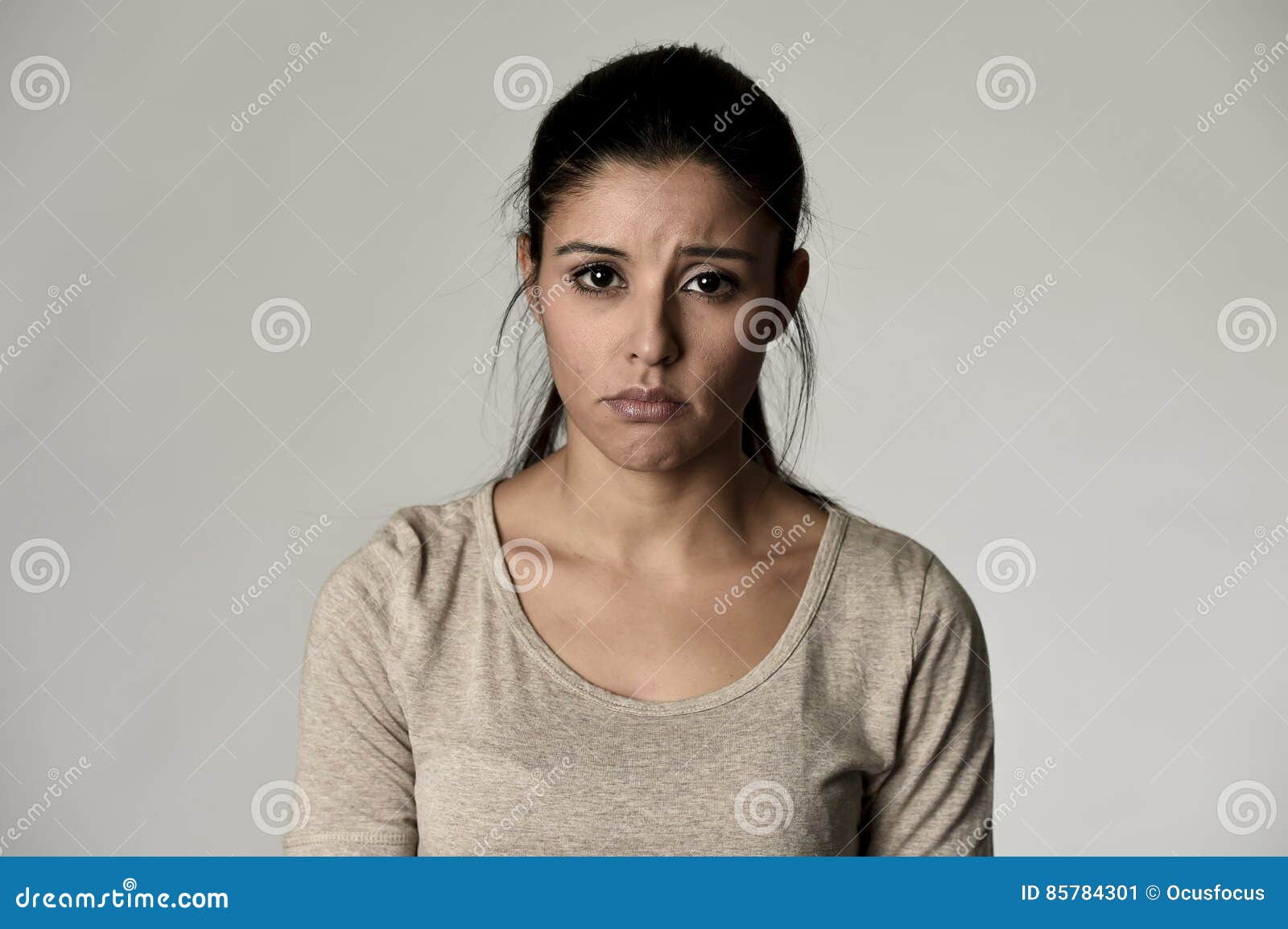 young beautiful hispanic sad woman serious and concerned in worried depressed facial expression