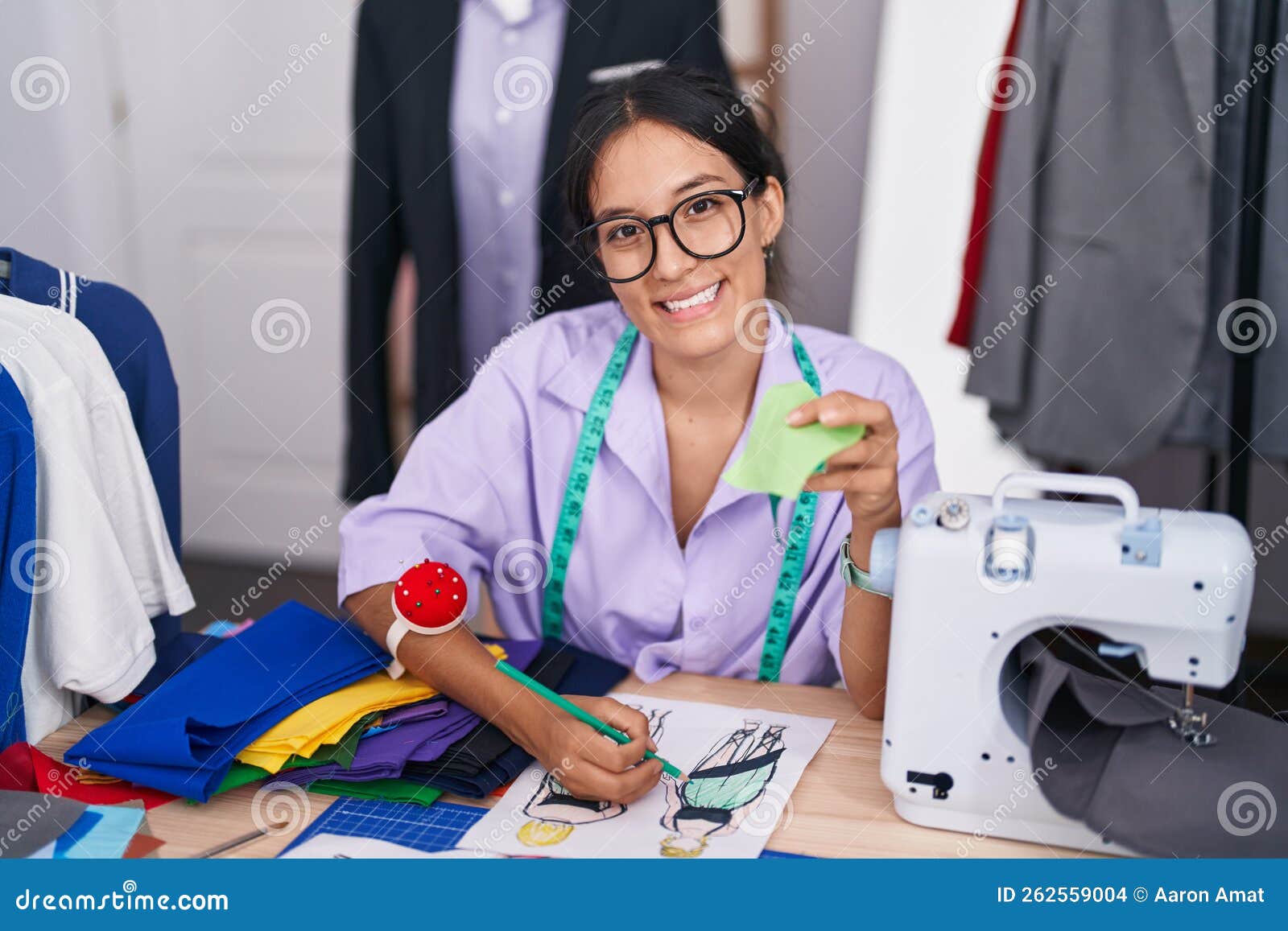 Young Beautiful Hispanic Woman Tailor Drawing Clothing Design Holding ...
