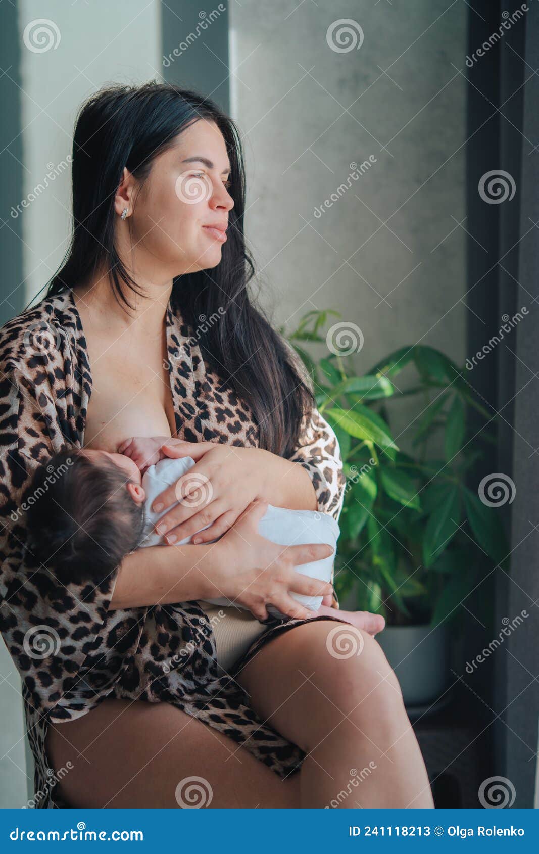 Young Beautiful Mother in Leopard Clothes Breastfeed Newborn Baby in White  Bodysuit Holding on Arms Looking Out Window. Stock Image - Image of care,  black: 241118213