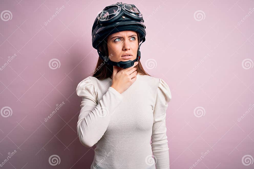 Young Beautiful Motorcyclist Woman with Blue Eyes Wearing Moto Helmet