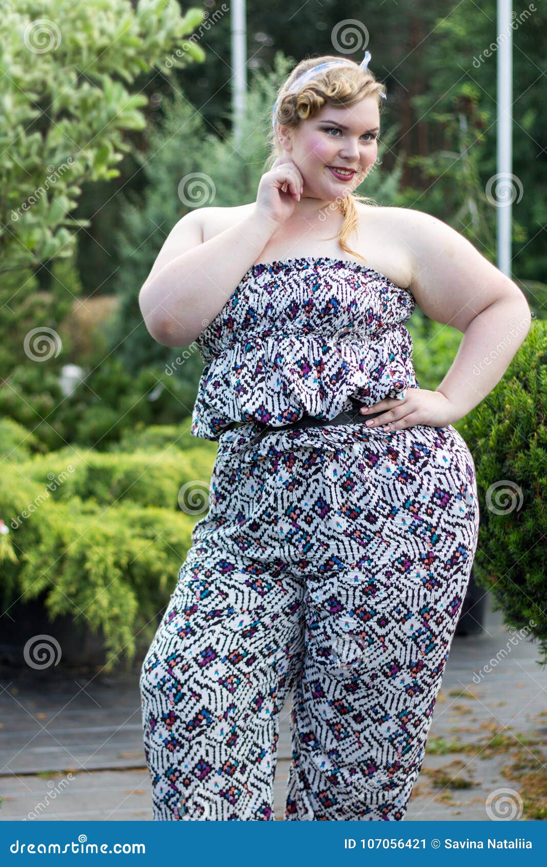 Young Beautiful Plus Size Girl among the Plants. Stock Image