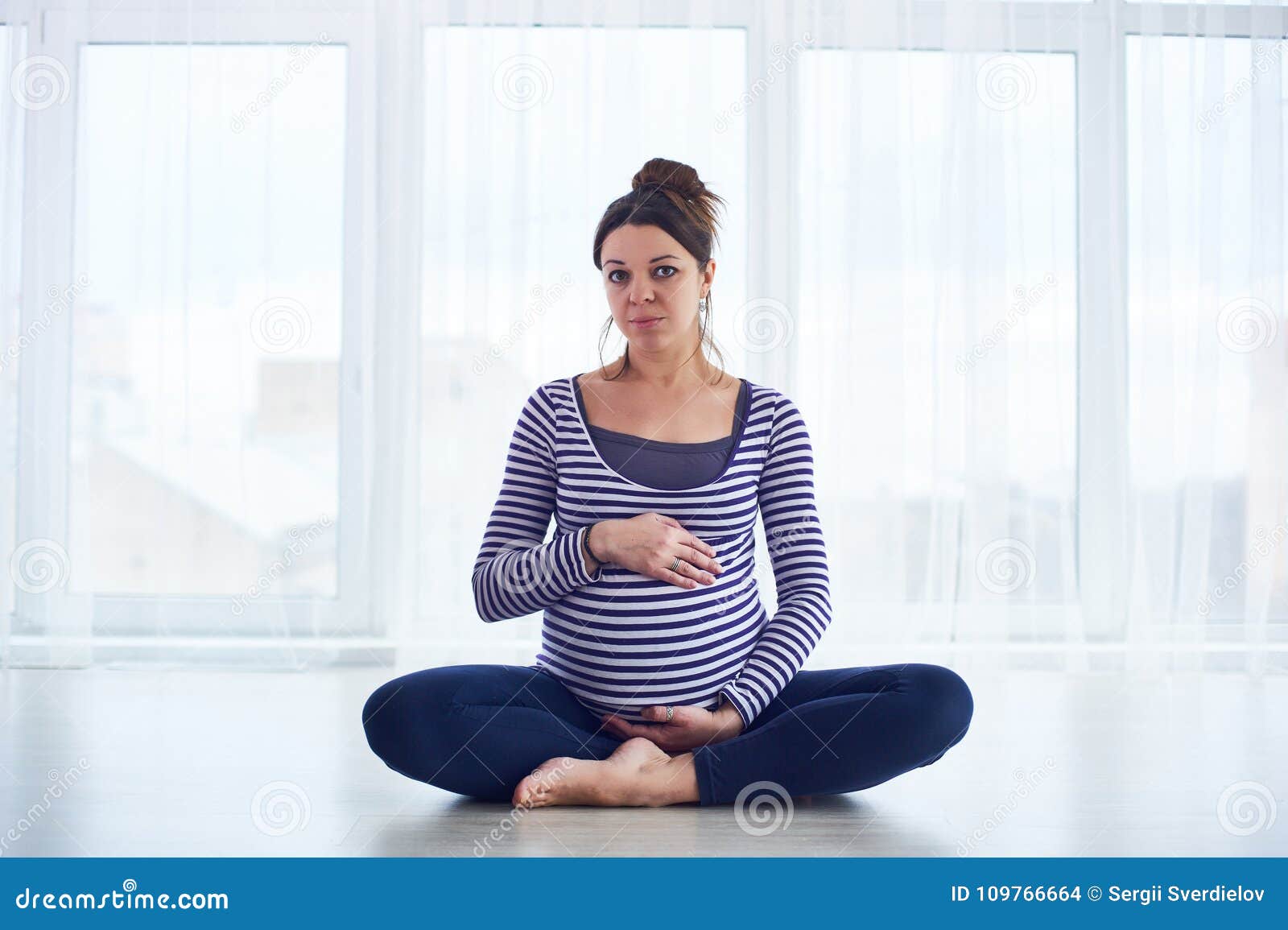 Barefooted black female meditating in Padmasana yoga pose with closed eyes  - a Royalty Free Stock Photo from Photocase
