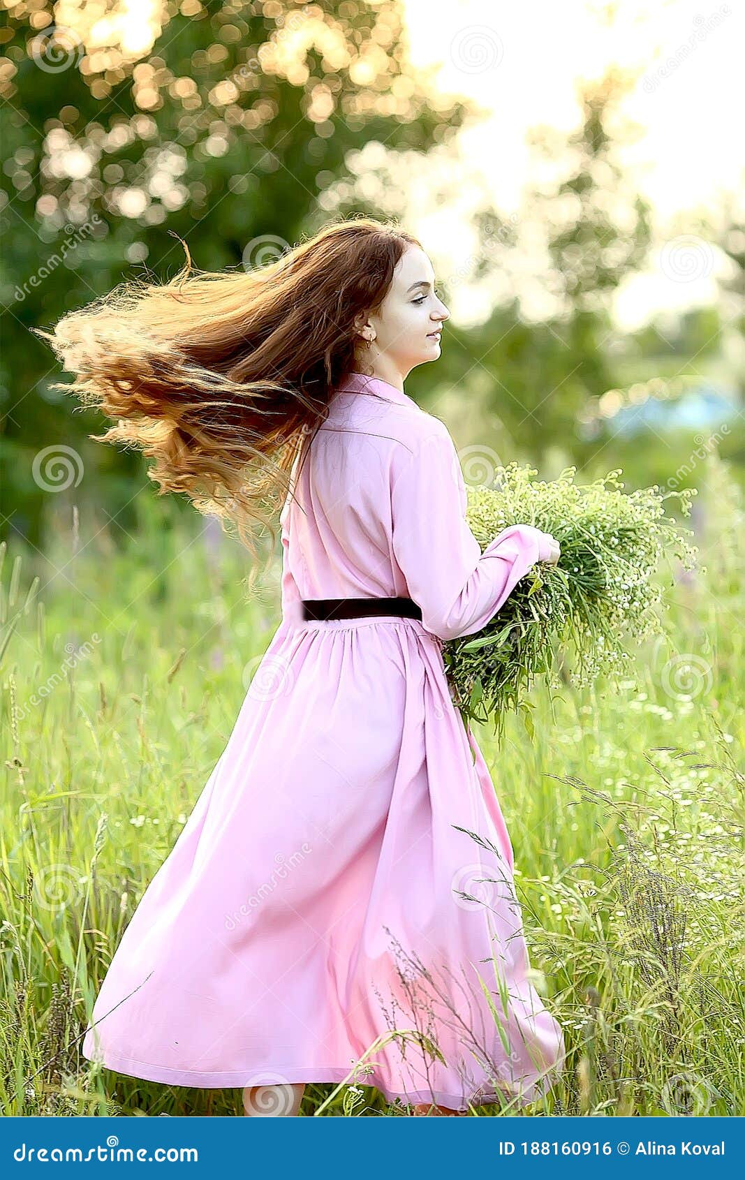 Young Beautiful Red-haired Girl in a Pink Dress is Spinning with a Huge ...