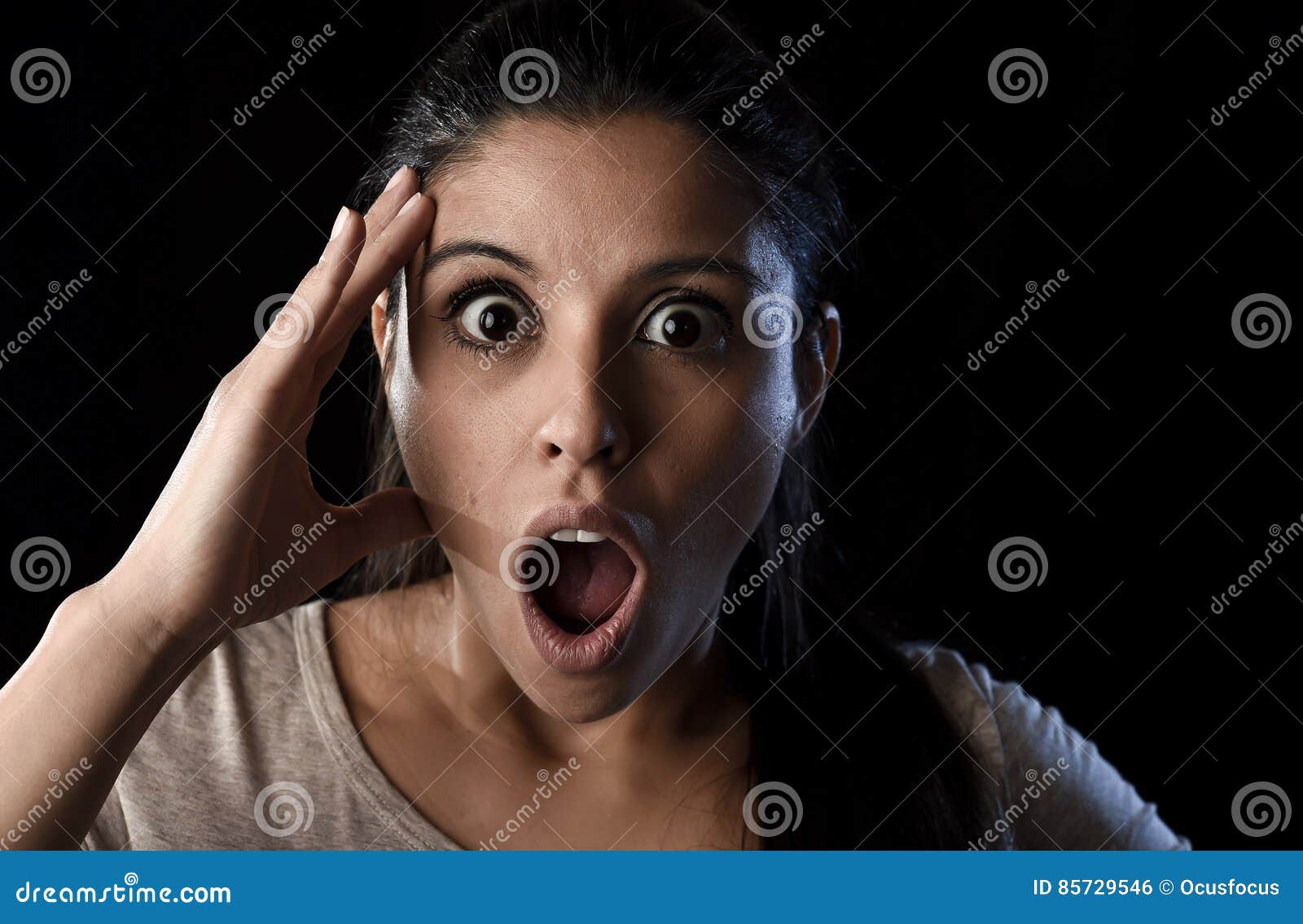 young beautiful scared Spanish woman in shock and surprise face
