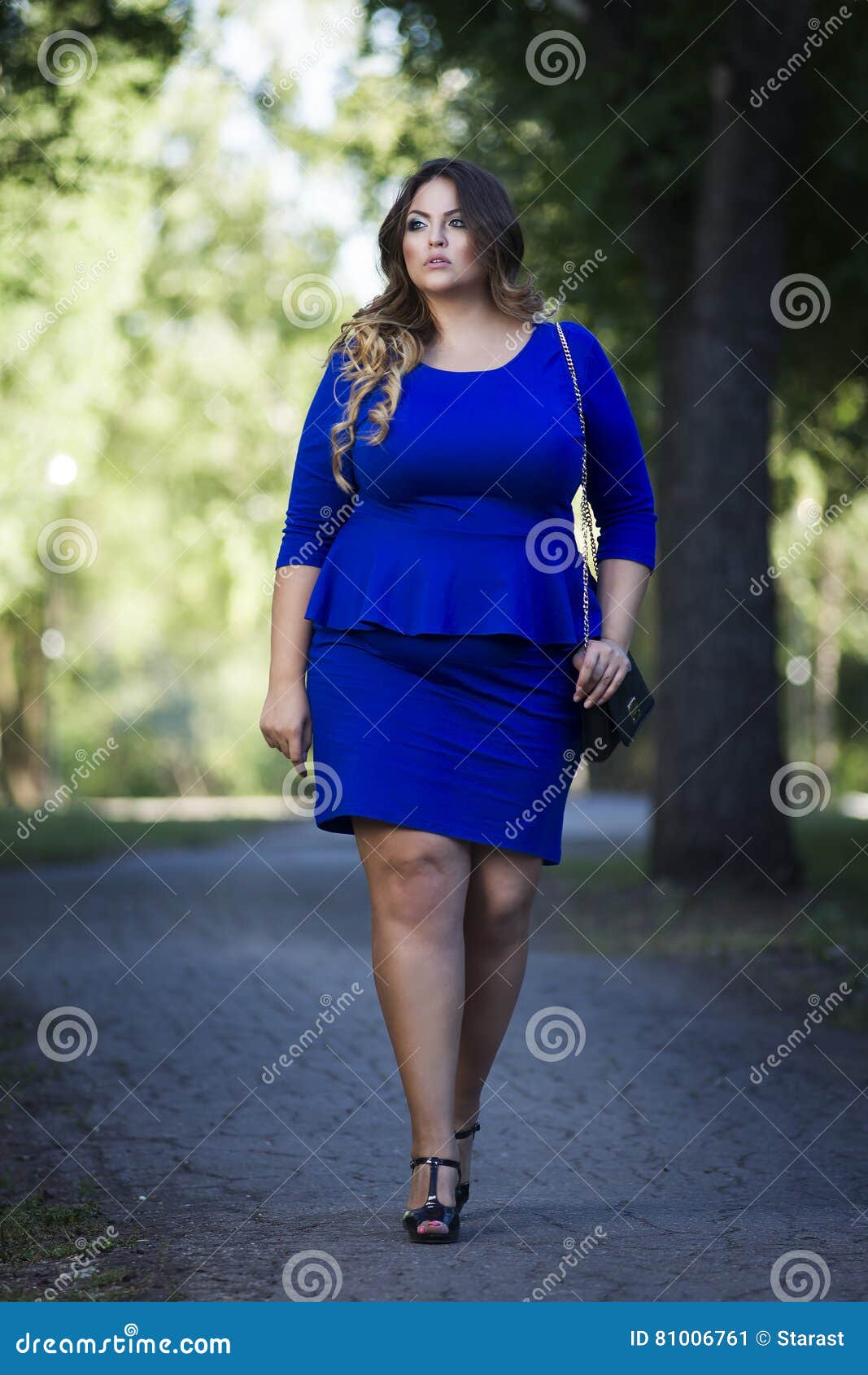 Young Beautiful Stylish Plus Size Fashion Model in Blue Dress
