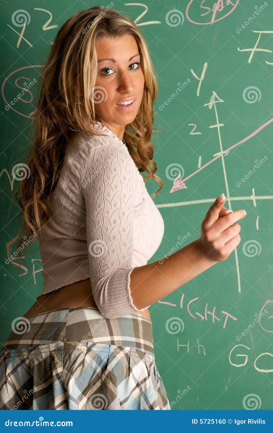 Beautiful Teacher With Piece Of Chalk On Blackboard Background Royalty