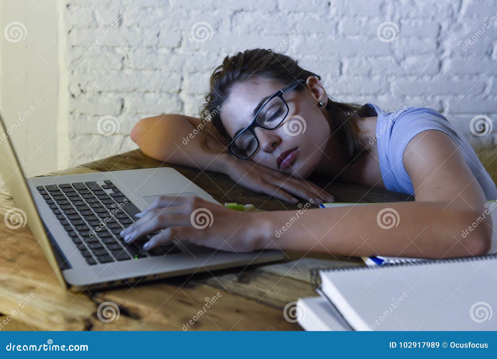 Young Beautiful And Tired Student Girl Sleeping Taking A Nap Lying