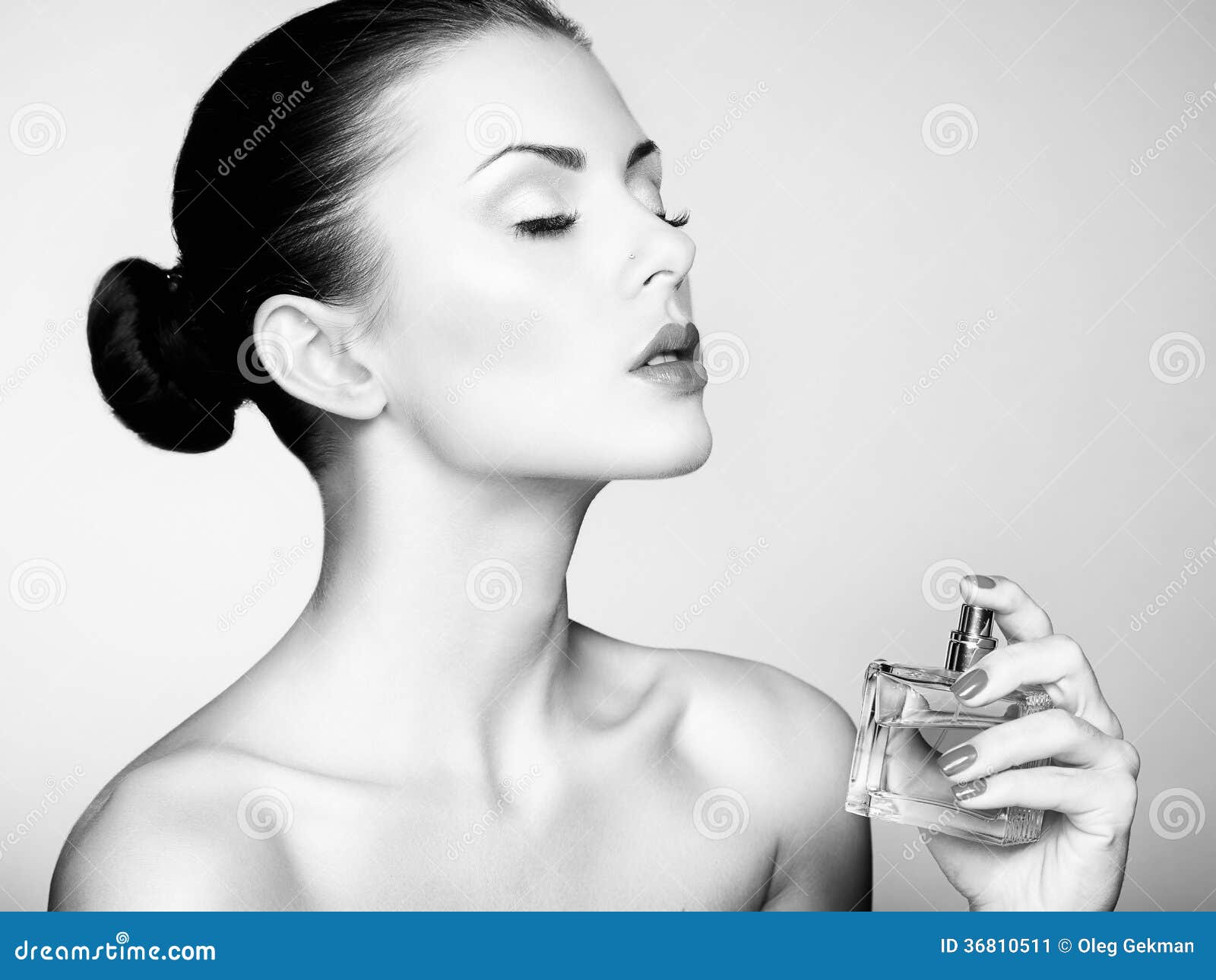 young beautiful woman with bottle of perfume. perfect makeup