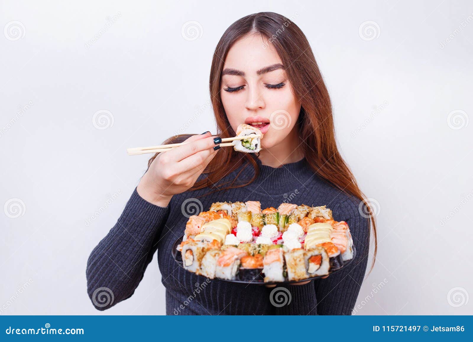 Young Beautiful Woman Eating Sushi, Studio Shoot on White Backgr Stock ...