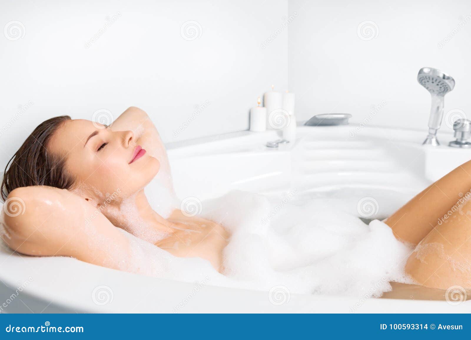 young woman enjoying bathing in bathtub