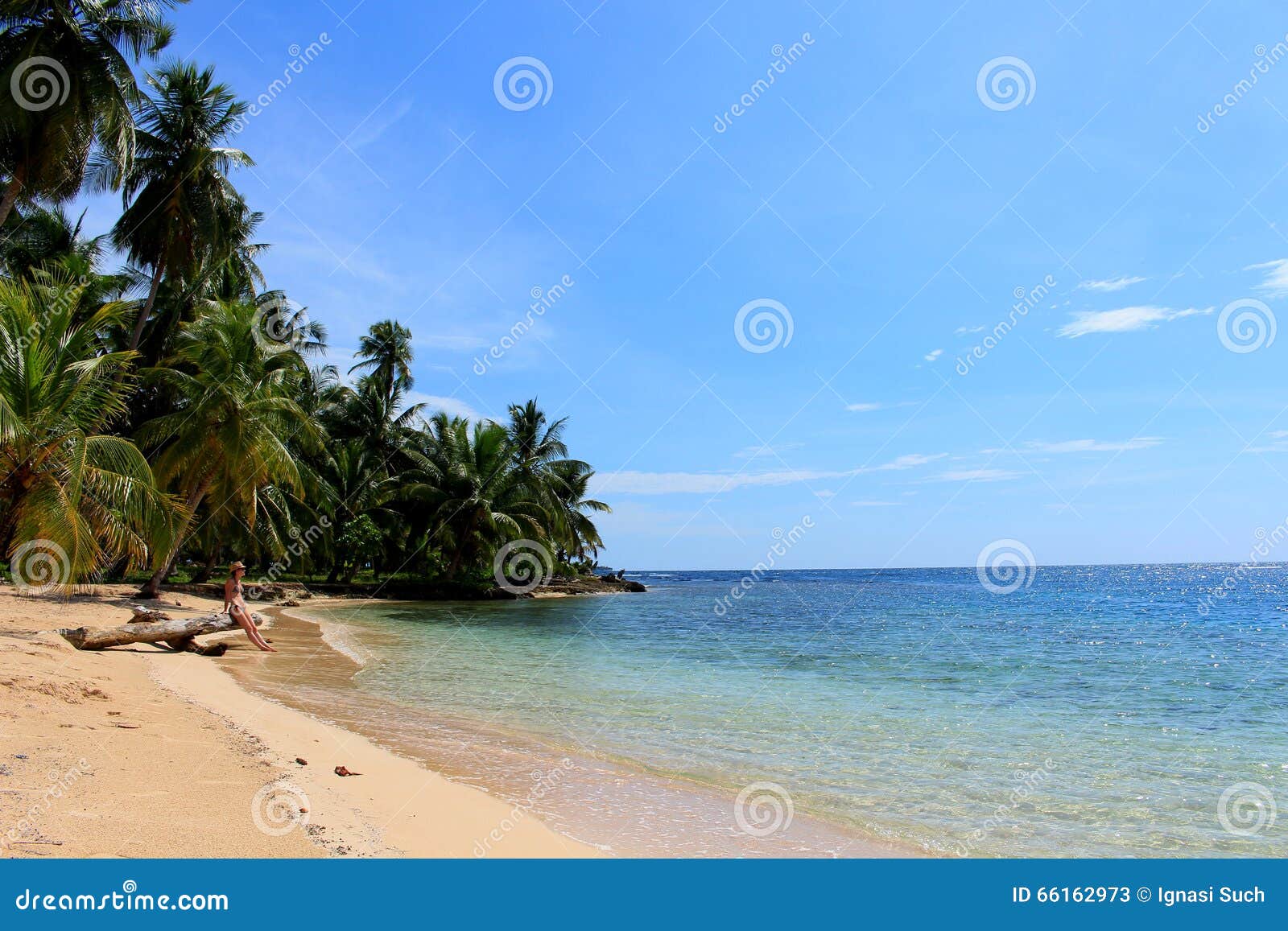 young beautiful woman enjoying her time and resting close to the sea in the southern beach of pelicano island, panama.