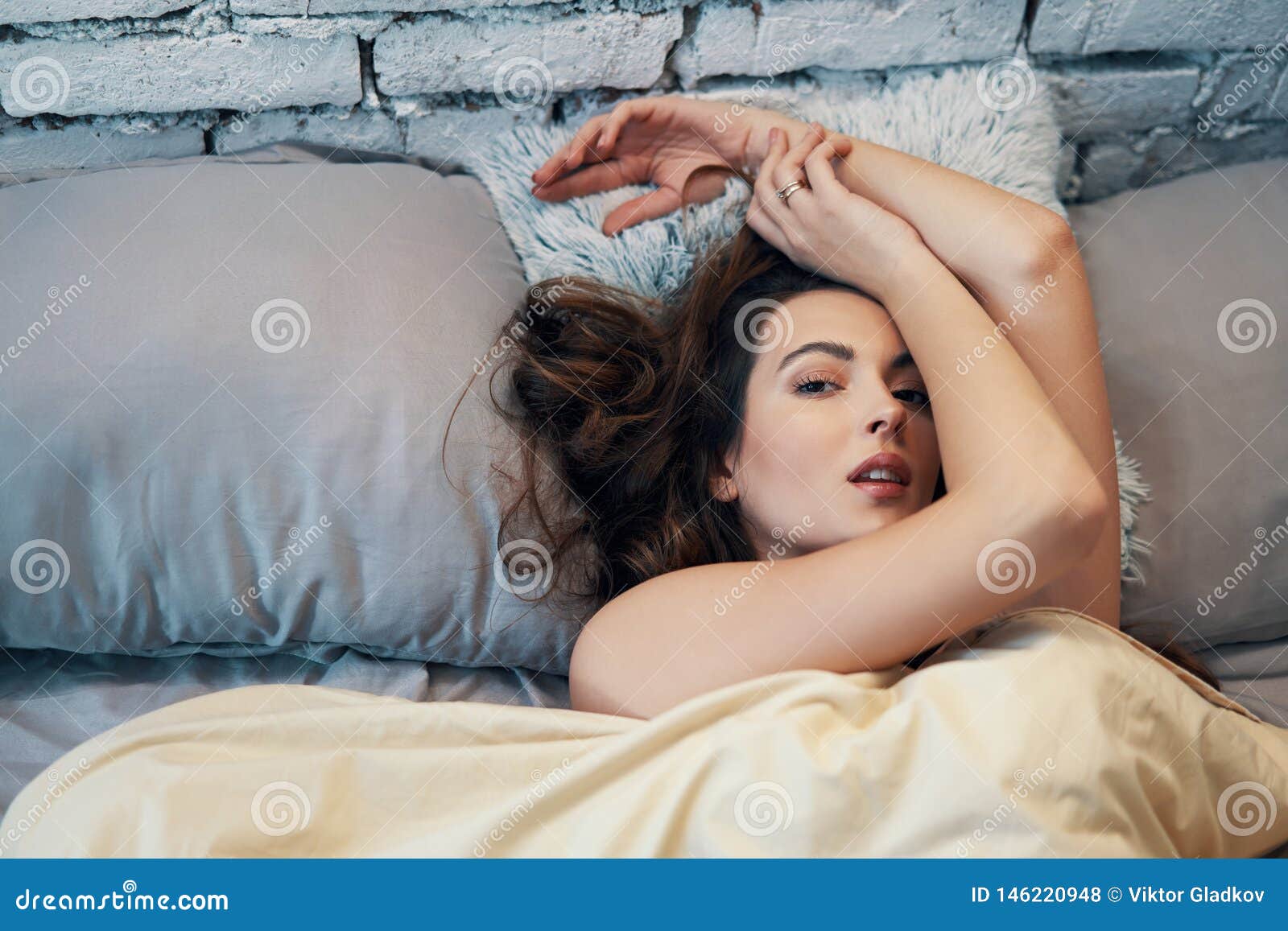 Young Beautiful Woman Lying And Relaxing In Bed In Her Bedroom Stock