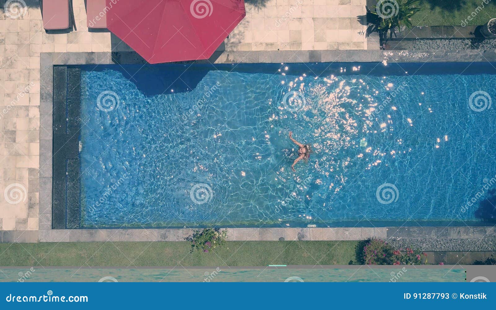 the young beautiful woman in the pool, flat lay, dron view, retro effect