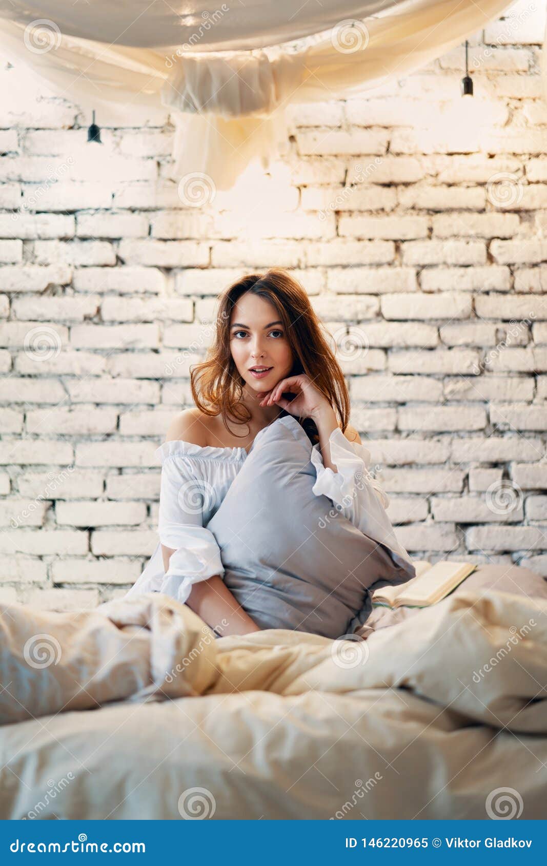 Young Beautiful Woman Posing In A Bedroom In Modern Apartment Stock