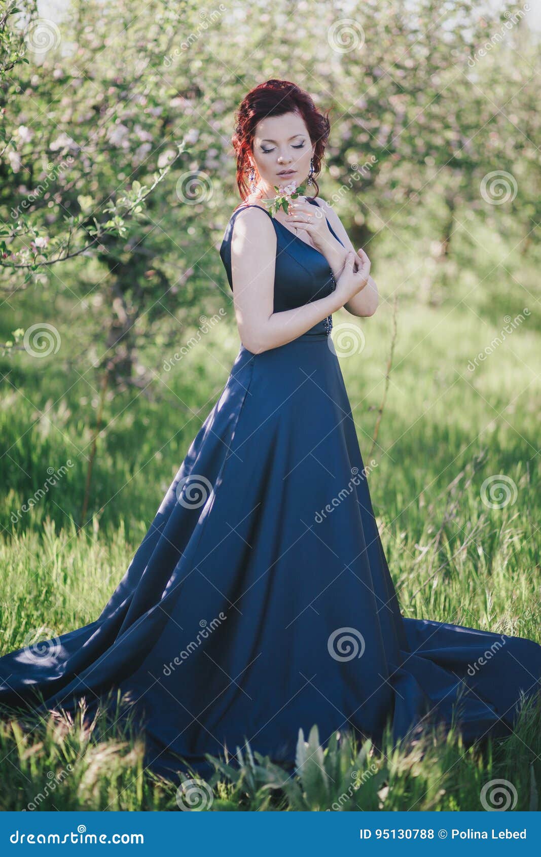 Young Beautiful Woman with Red Hair in a Blue Dress Posing in a ...