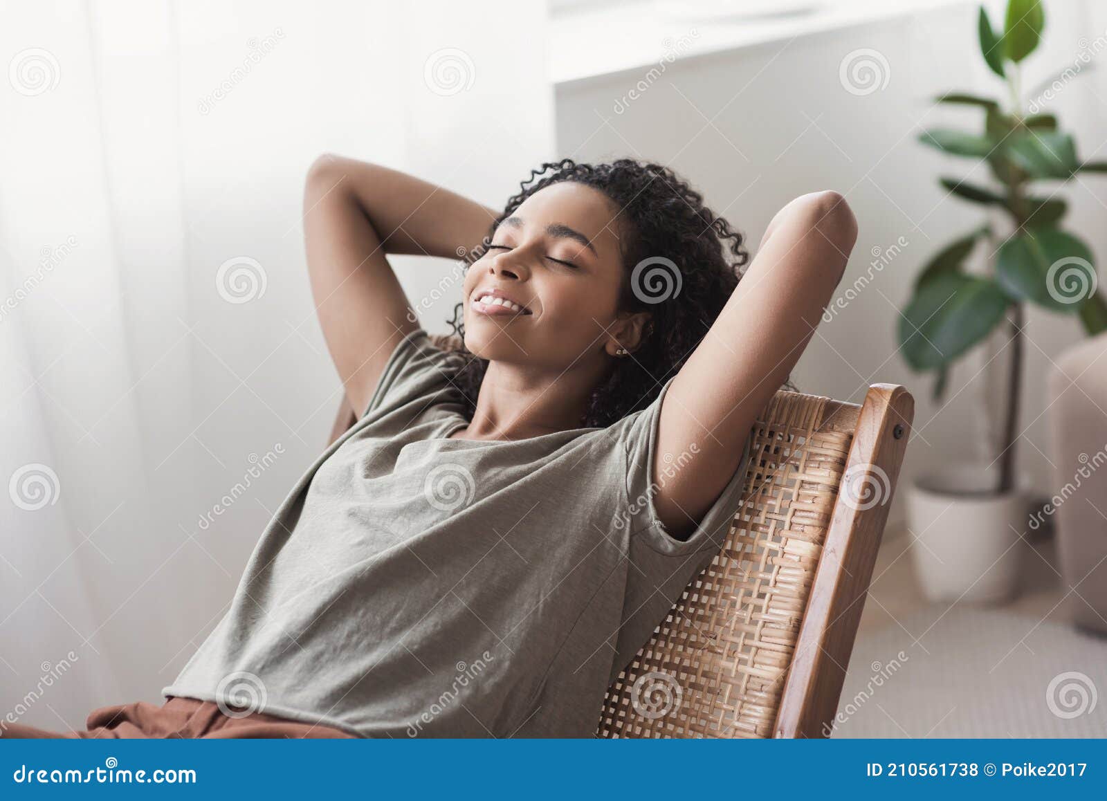 young beautiful woman relaxing at home. cute african american girl resting in her room