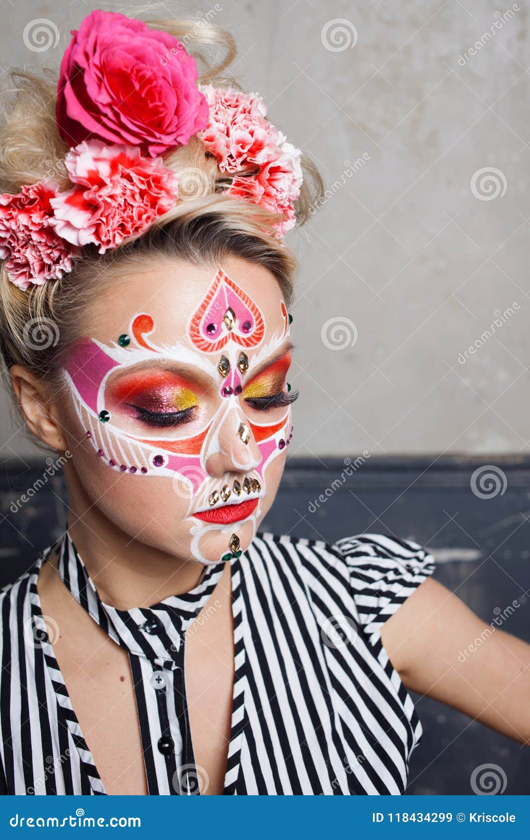 young beautiful woman with skull makeup. mexican day of the