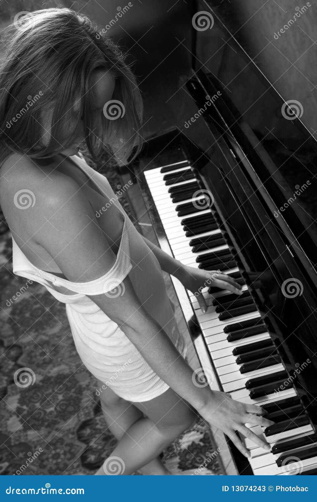 Young Beautiful Woman In A Vest Playing The Piano Stock Photos - Image