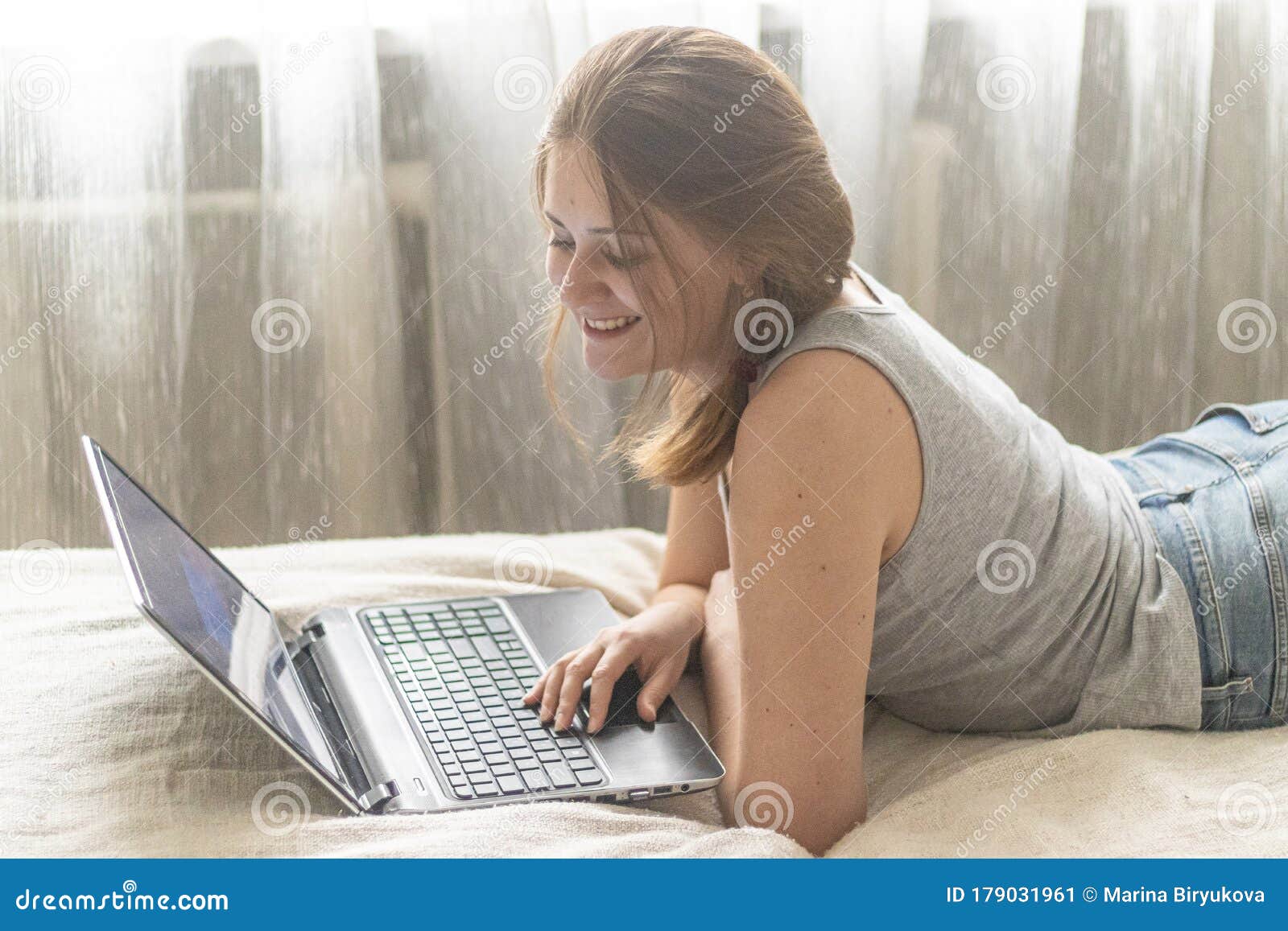 Young Beautiful Woman Watching Movie Online. Watching Funny Content, Images  or Videos. Cute Girl Sitting with Computer and Doing Stock Image - Image of  female, fullbody: 179031961
