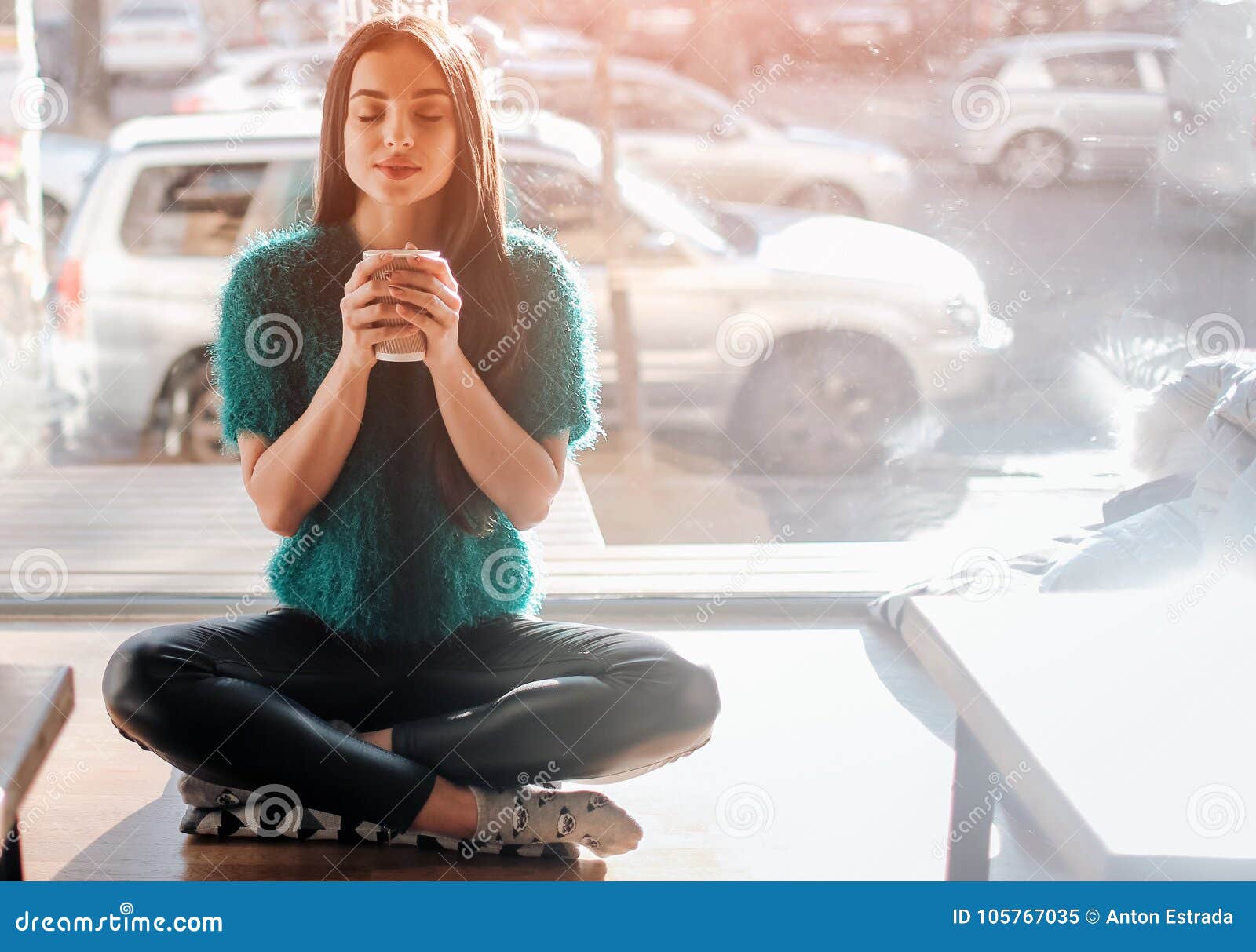 Young Beautiful Woman Drinking Coffee at Cafe Bar. Female Model in the