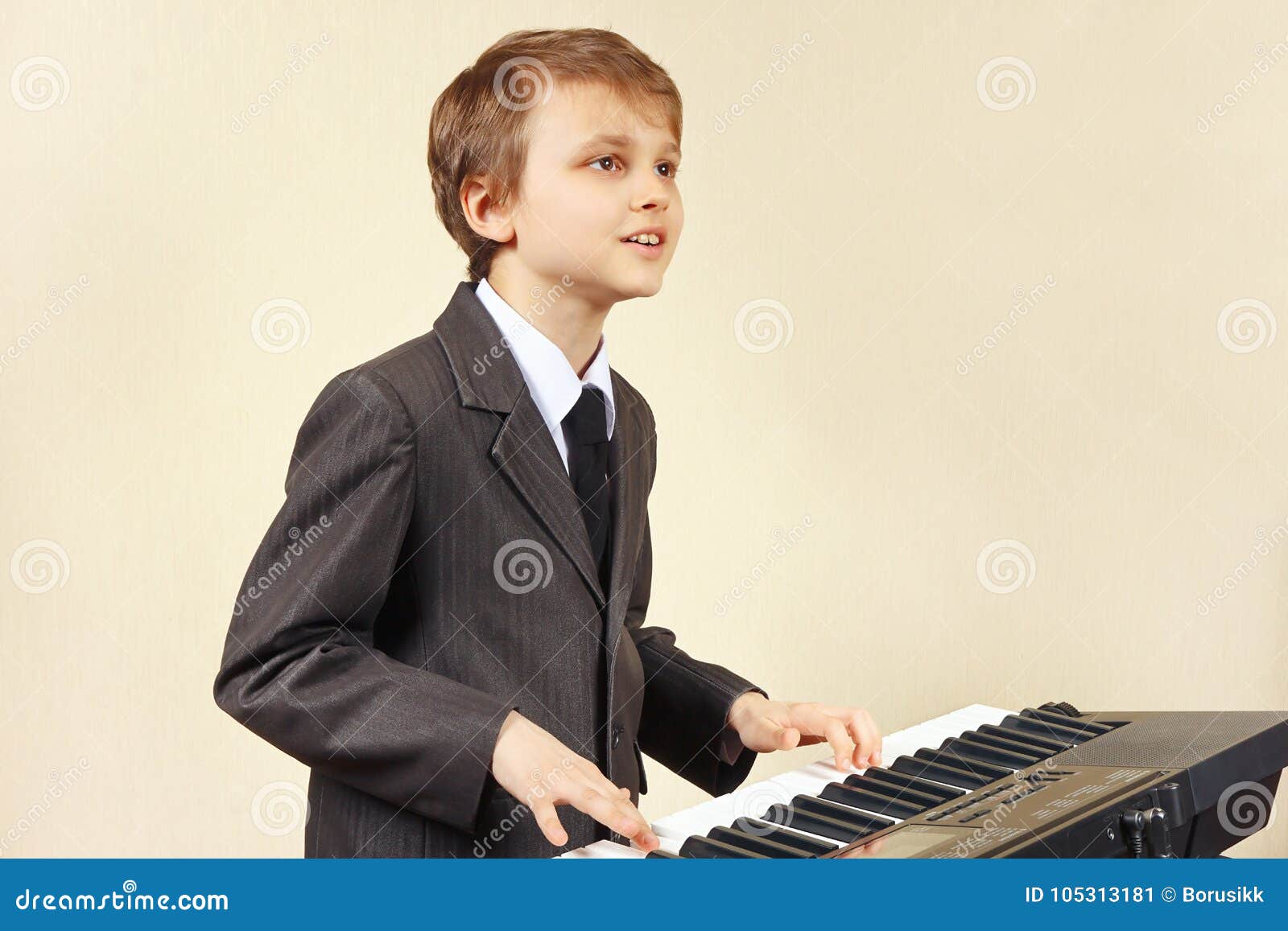 Young Beginner Musician in Suit Playing the Electronic Synth Stock