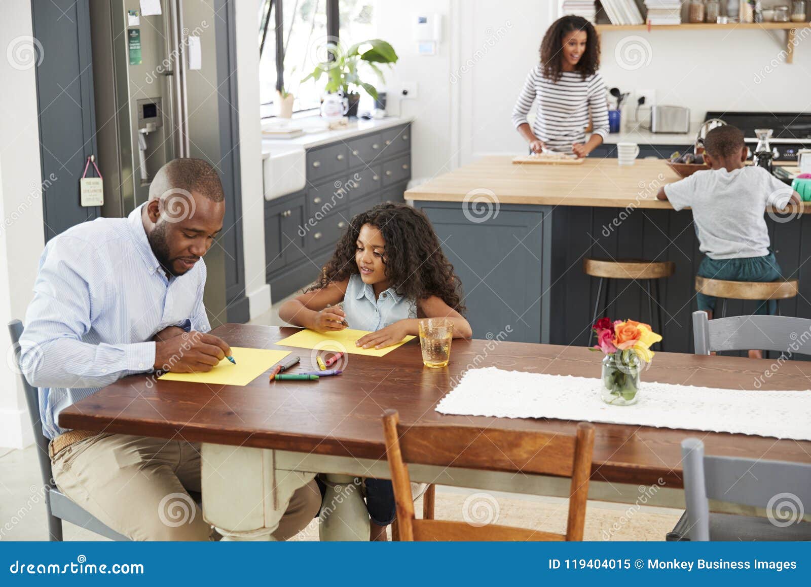 young black family busy in their kitchen, elevated view