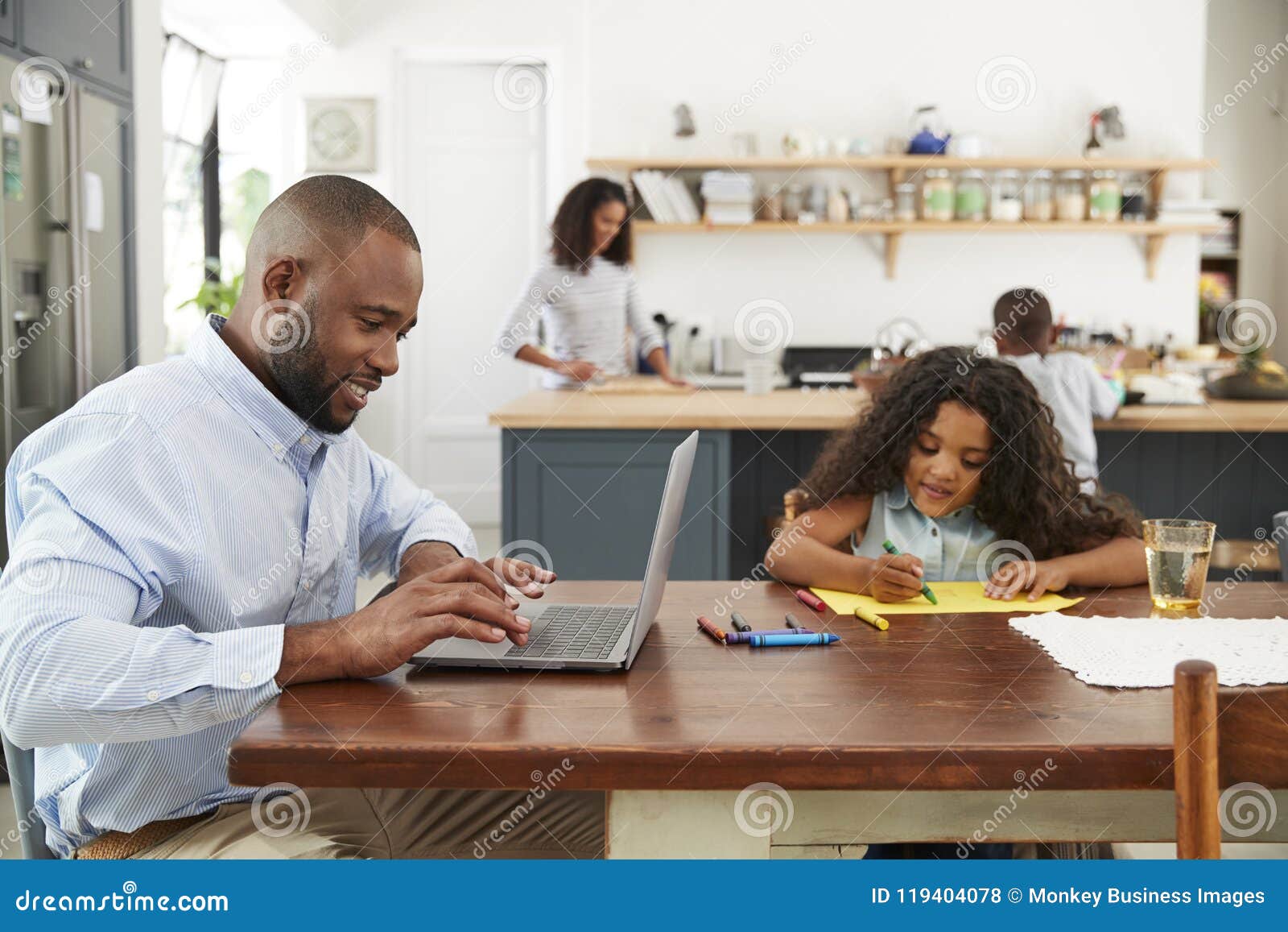 young black family busy working in their kitchen