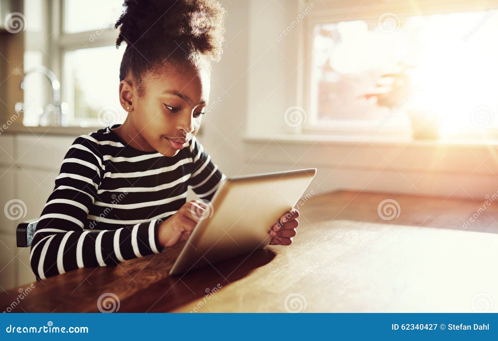 young black girl browsing on a tablet-pc