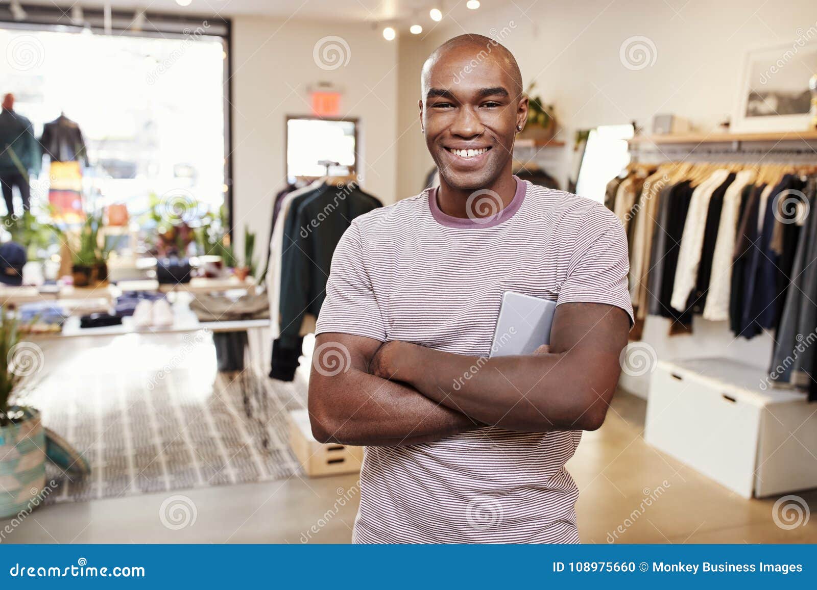 Young Black Man Smiling To Camera in a Clothes Shop Stock Photo - Image ...