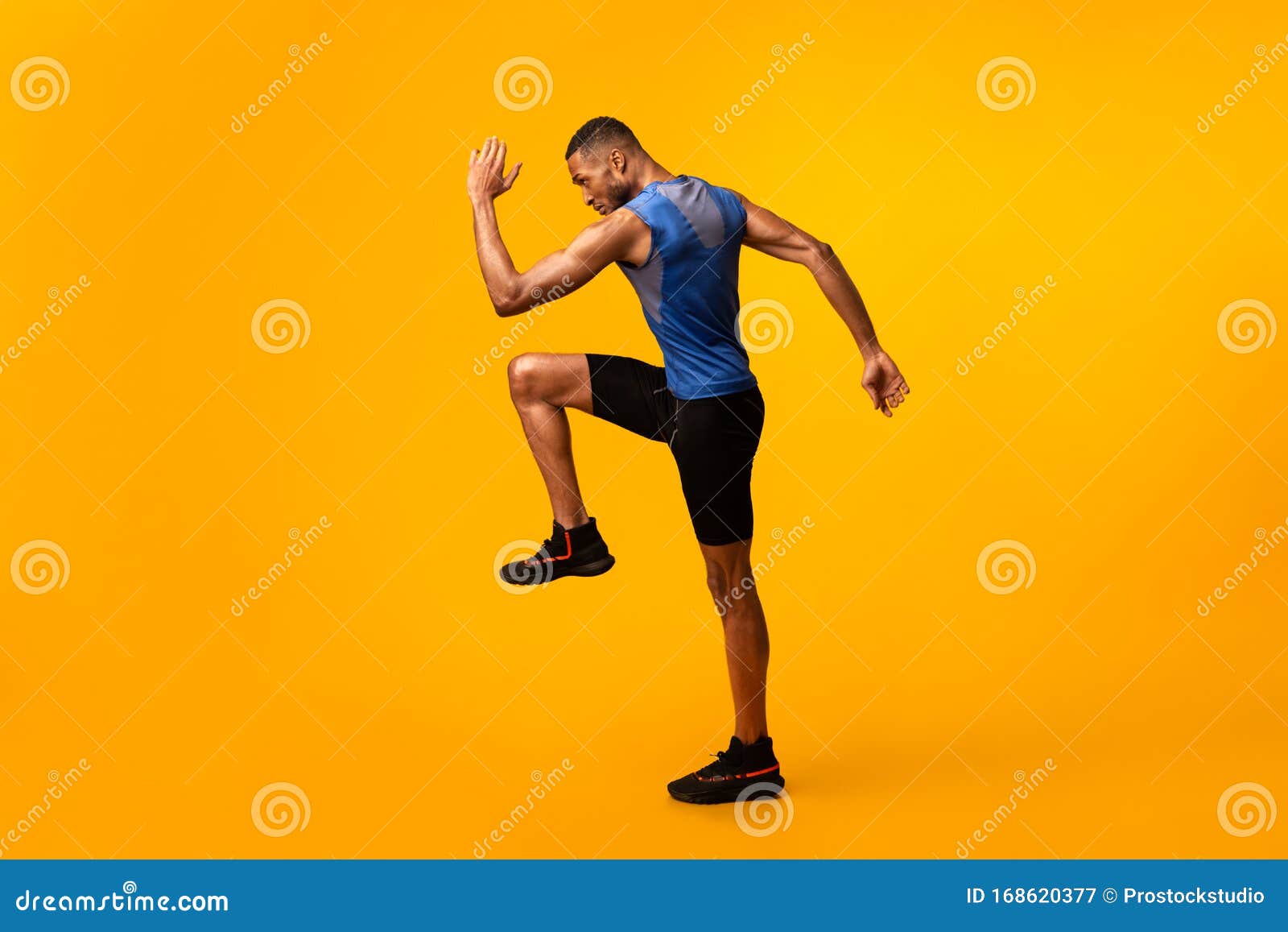 young black sportsman walks highly lifting knees