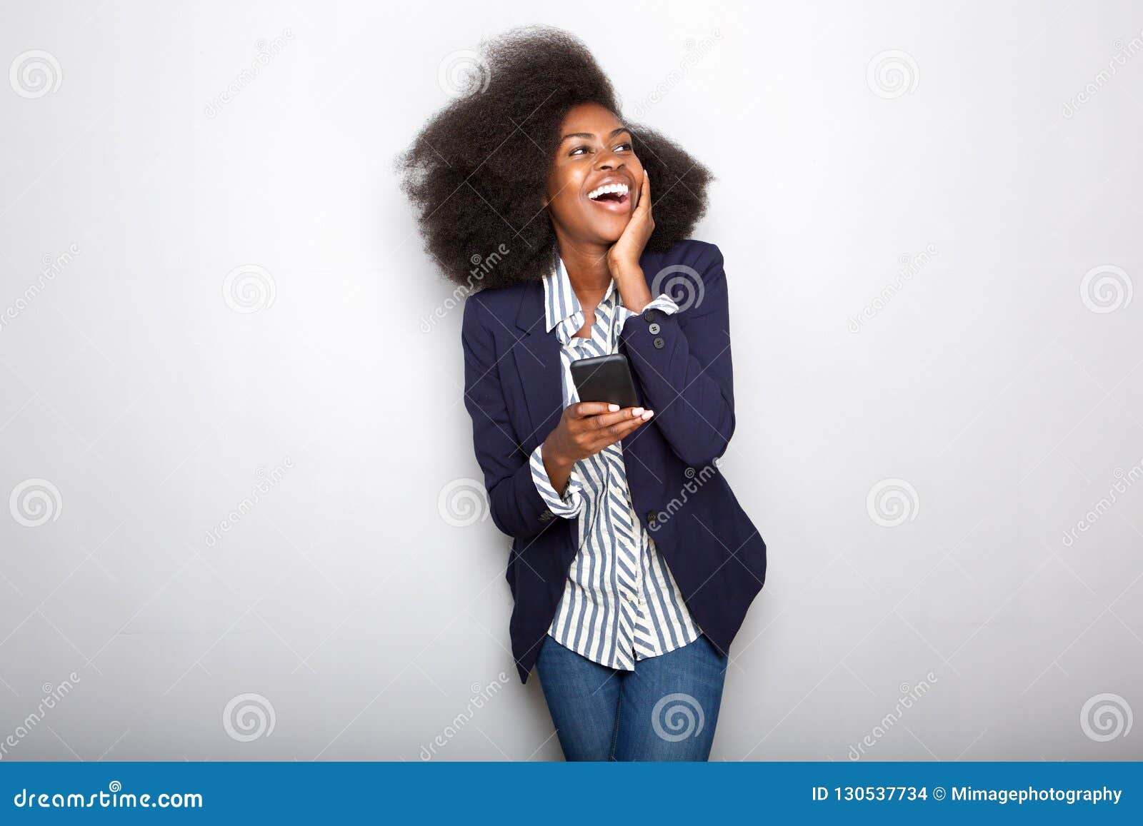 young black woman laughing with cellphone