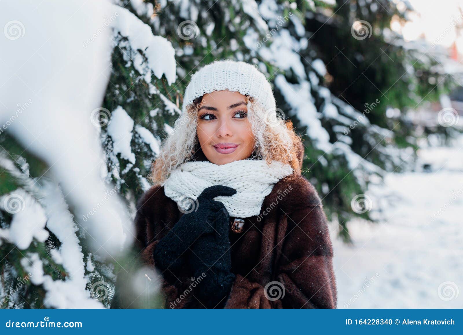 Young Black Woman Wearing in Fur Coat and Knitted Hat Walking in Winter ...