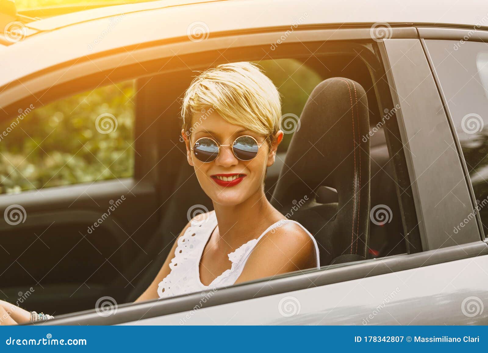 Young Blonde Attractive Woman Smiling And Looking Straight While