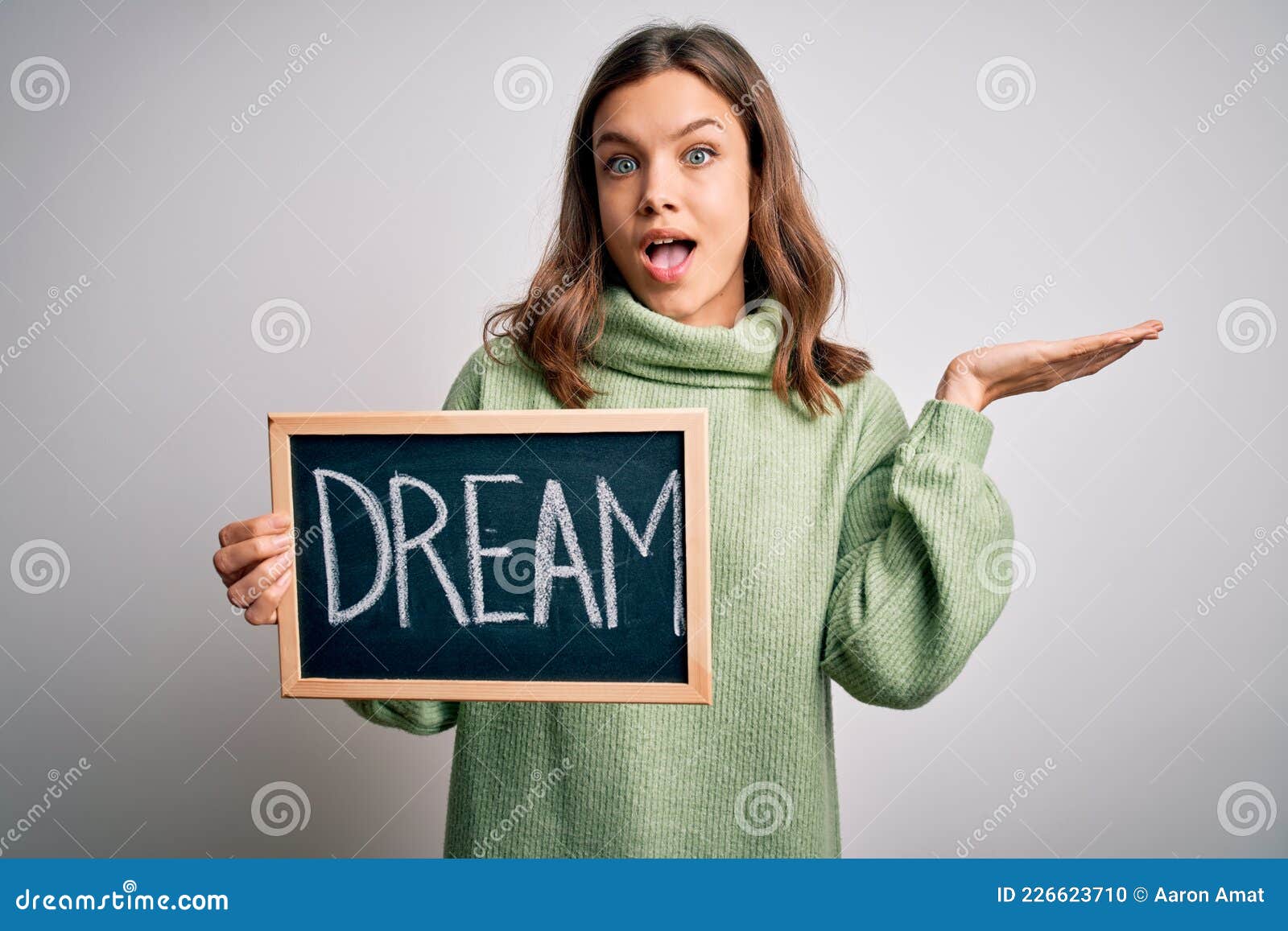 Young Blonde Girl Holding Blackboard with Dream Word As Happiness Message  Very Happy and Excited, Winner Expression Celebrating Stock Photo - Image  of smile, teenager: 226623710