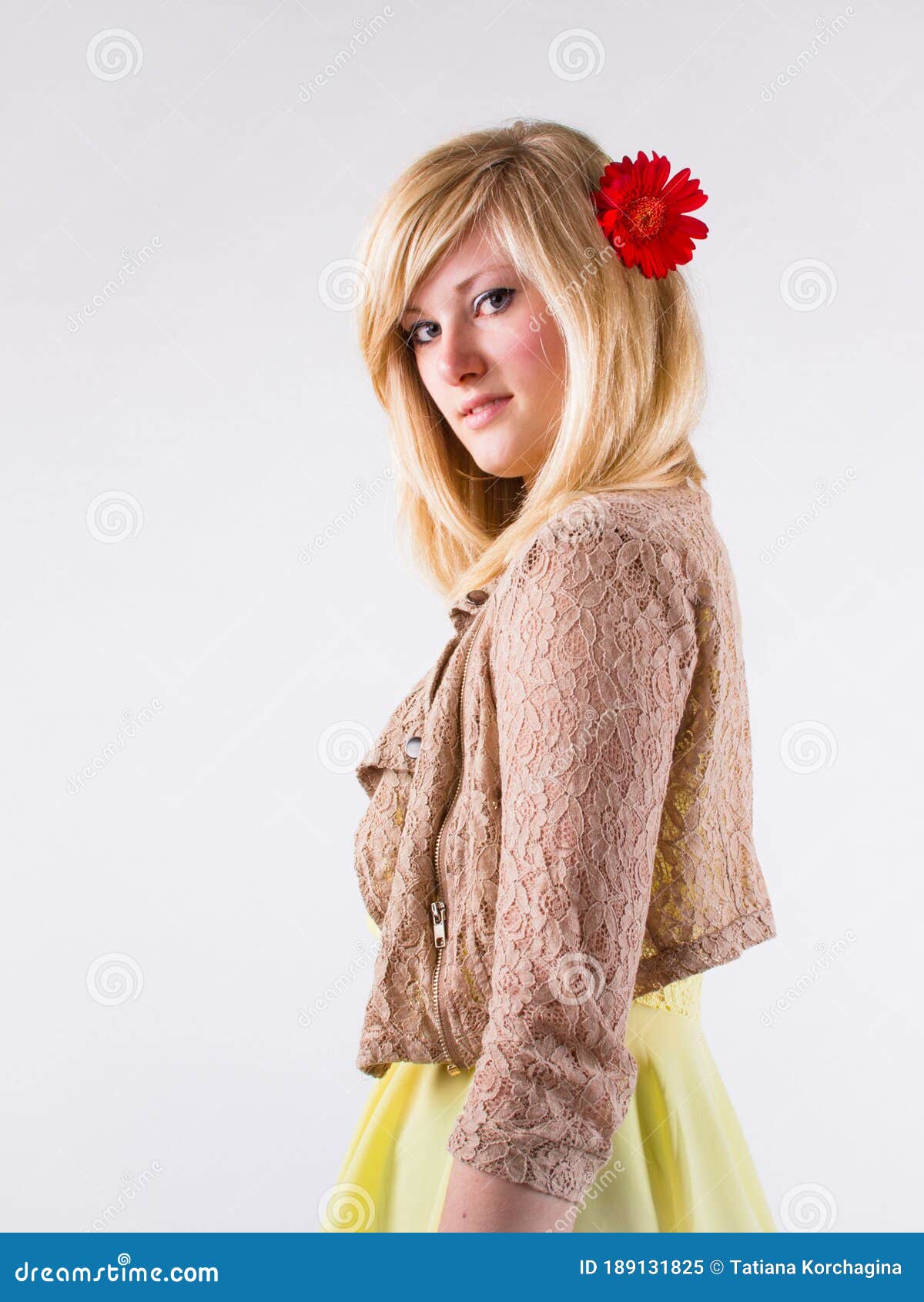 Young Blonde with a Red Gerbera Flower in Her Straight Hair, Standing in  Profile and Looking at Camera Stock Image - Image of blue, happy: 189131825