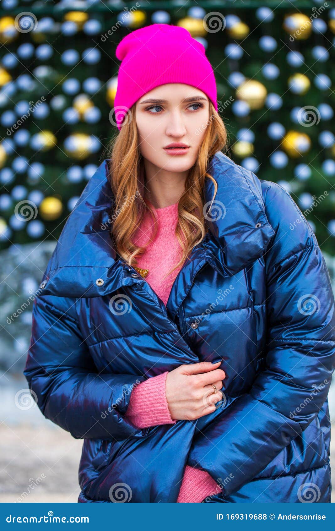 Young Blonde Woman in Blue Down Jacket in Winter Street Stock Photo ...