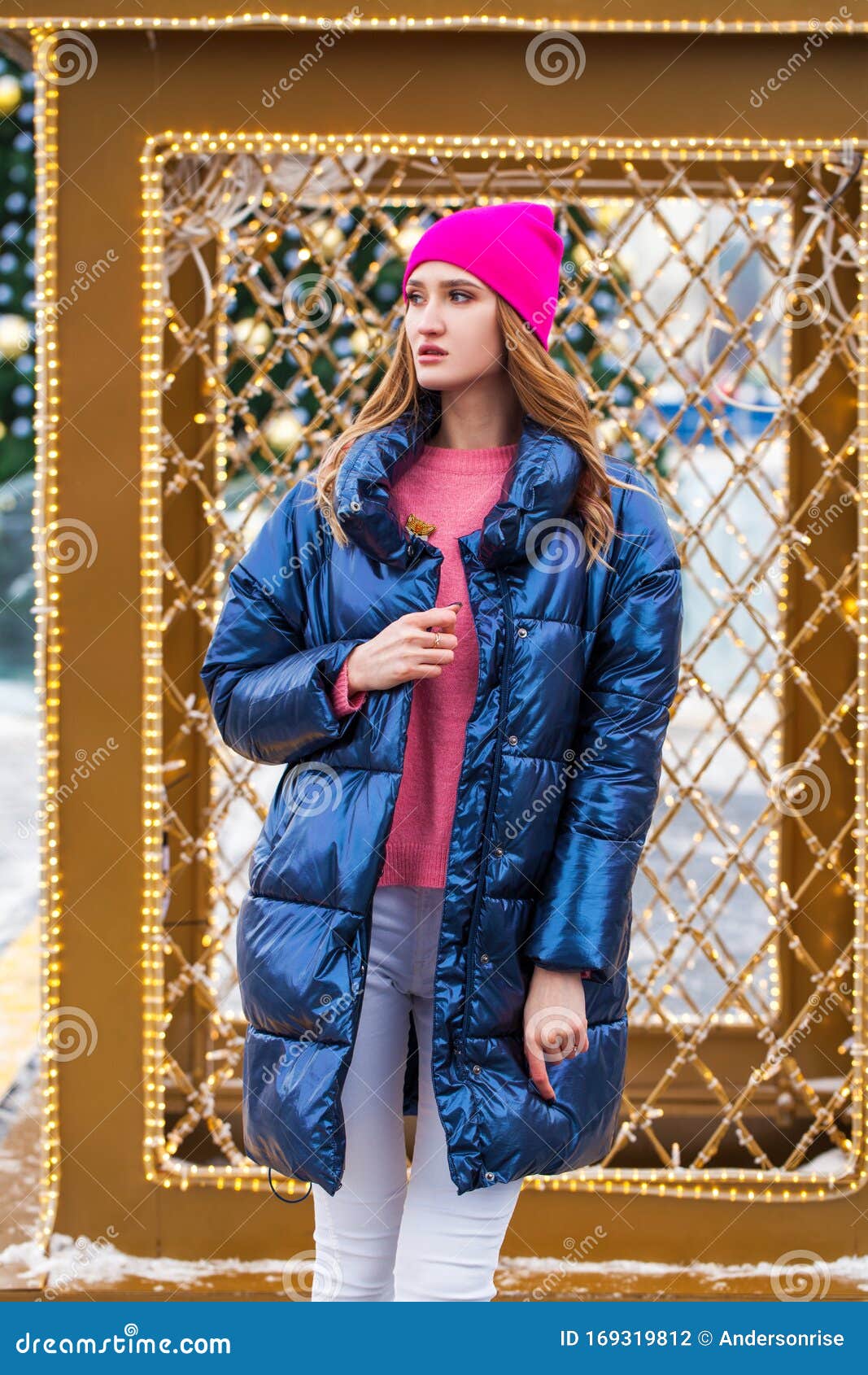 Young Blonde Woman in Blue Down Jacket in Winter Street Stock Photo ...