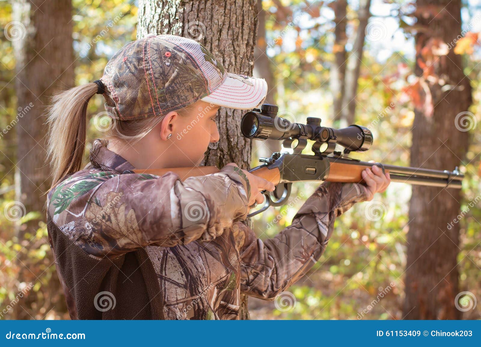 young-blonde-woman-hunting-aiming-rifle-wooded-area-wearing-camouflage-61153409.jpg