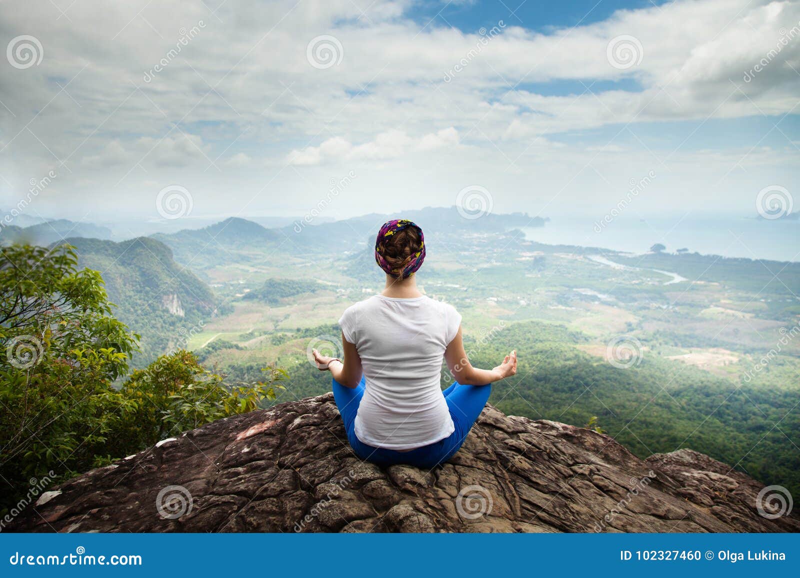 young blonde woman practicing yoga and meditation in mountains during luxury yoga retreat in bali, asia