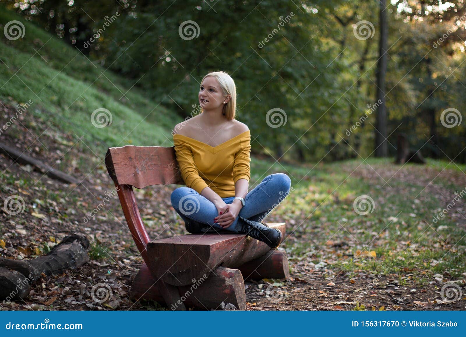 Young Blonde Woman Resting on a Bench in the Forest Stock Photo - Image ...