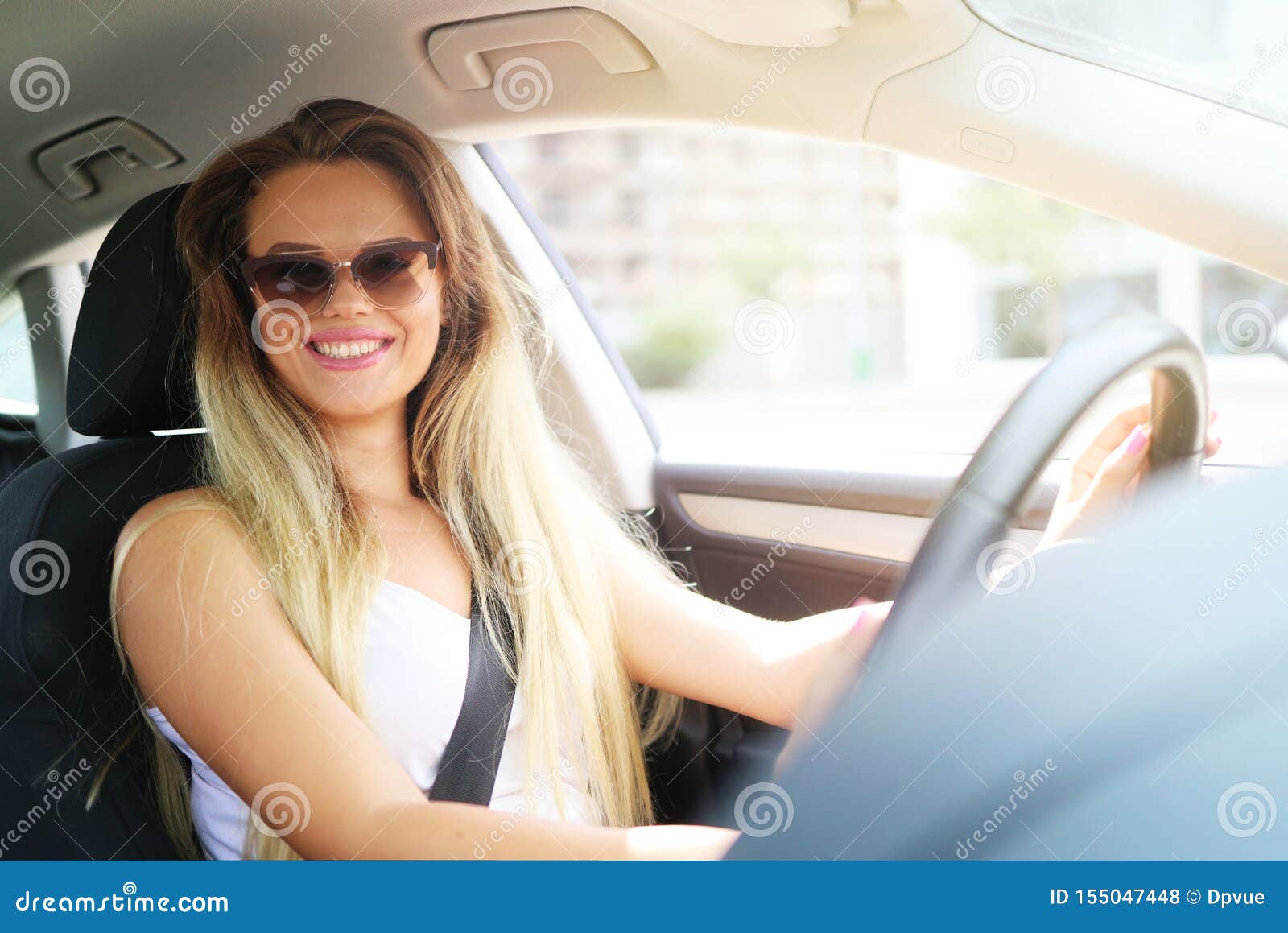 Young Blonde Woman Smiling While Driving A Car Rent A Car In Vacation