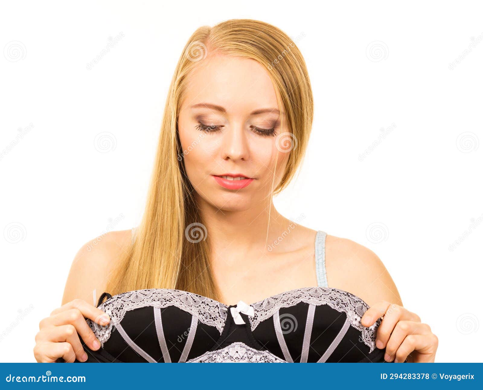 Woman trying on black bra - Stock Photo [66768745] - PIXTA