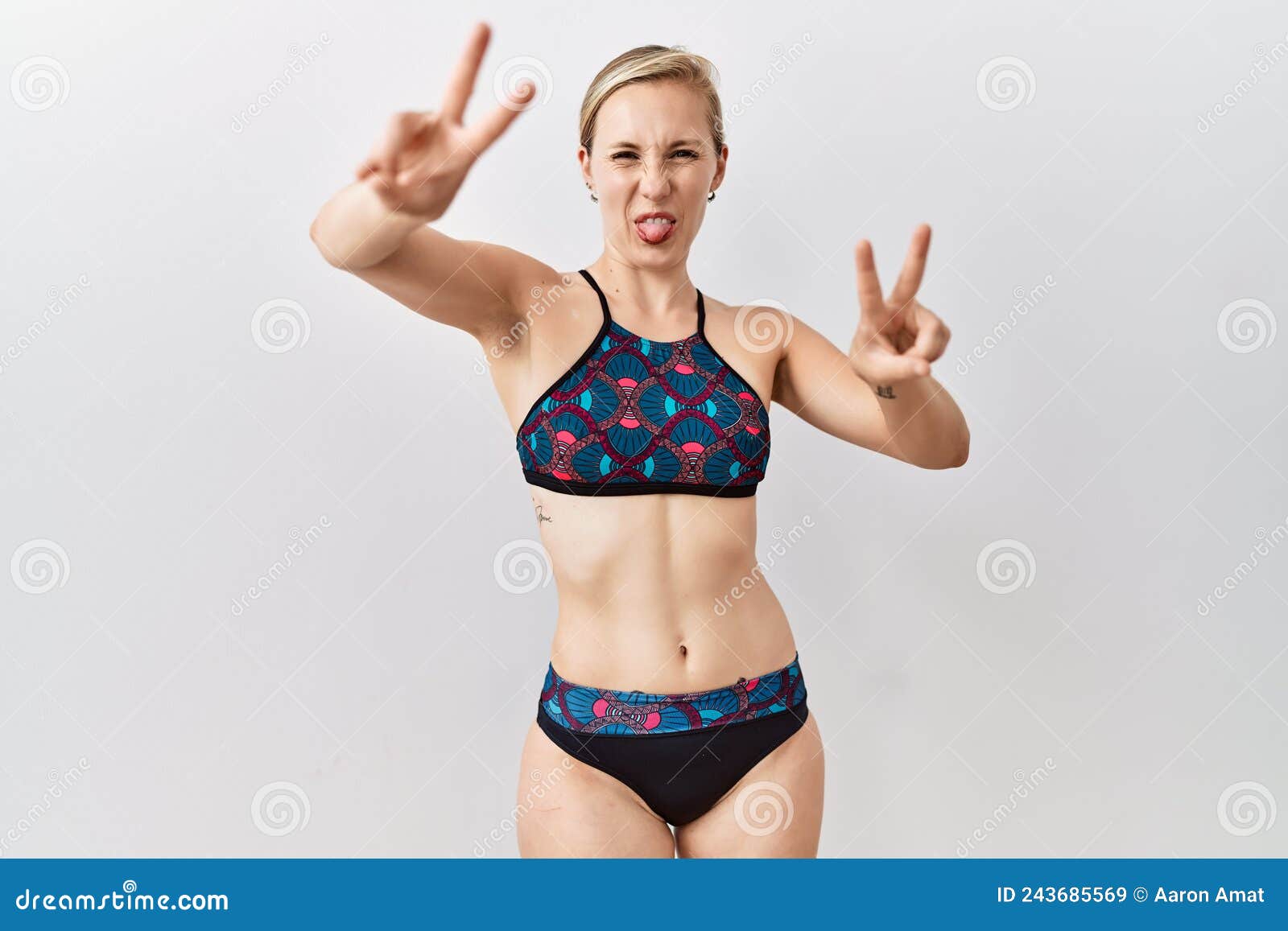 Young Blonde Woman Wearing Sporty Bikini Over Isolated Background Smiling  with Tongue Out Showing Fingers of Both Hands Doing Stock Image - Image of  gesture, body: 243685569