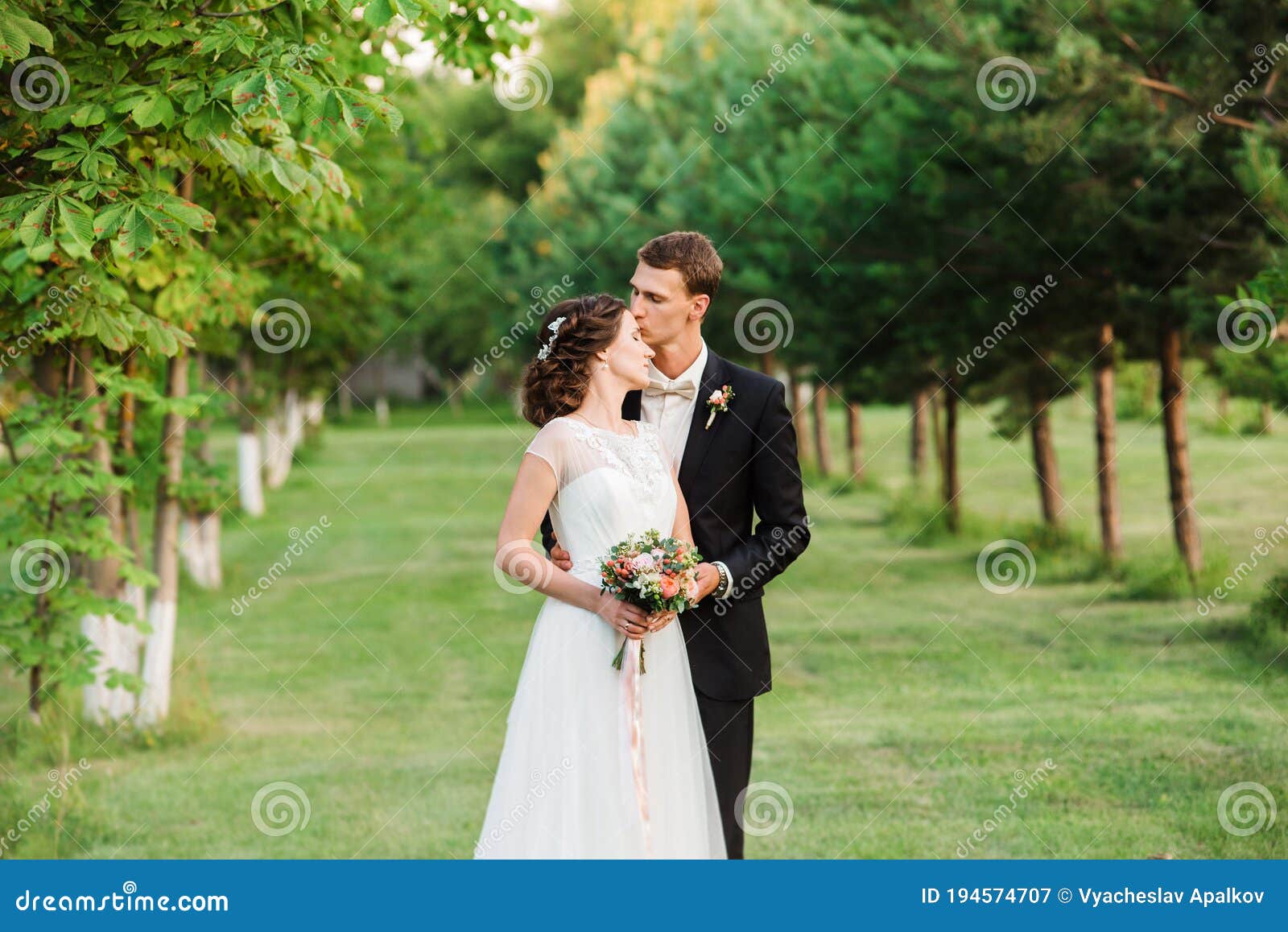 https://thumbs.dreamstime.com/z/young-bloom-wedding-suit-kissing-his-beautiful-bride-s-forehead-summer-garden-photo-194574707.jpg