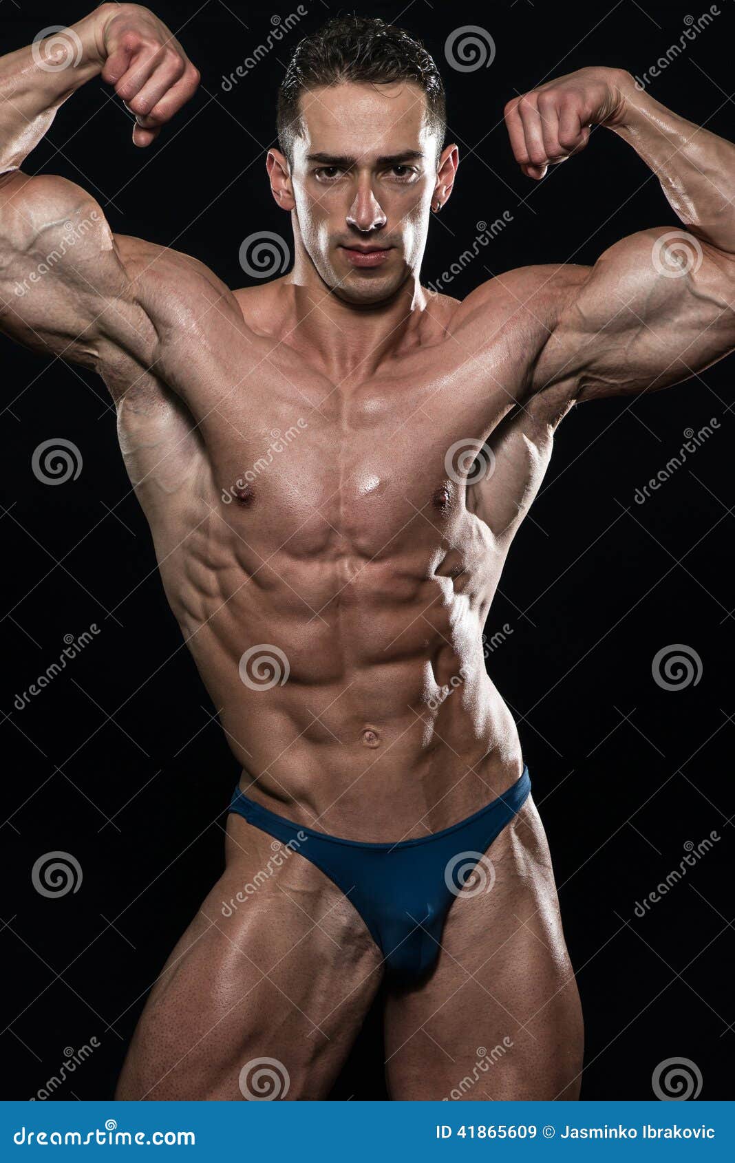 Young Bodybuilder Flexing Muscles Isolate on Black Blackground Stock