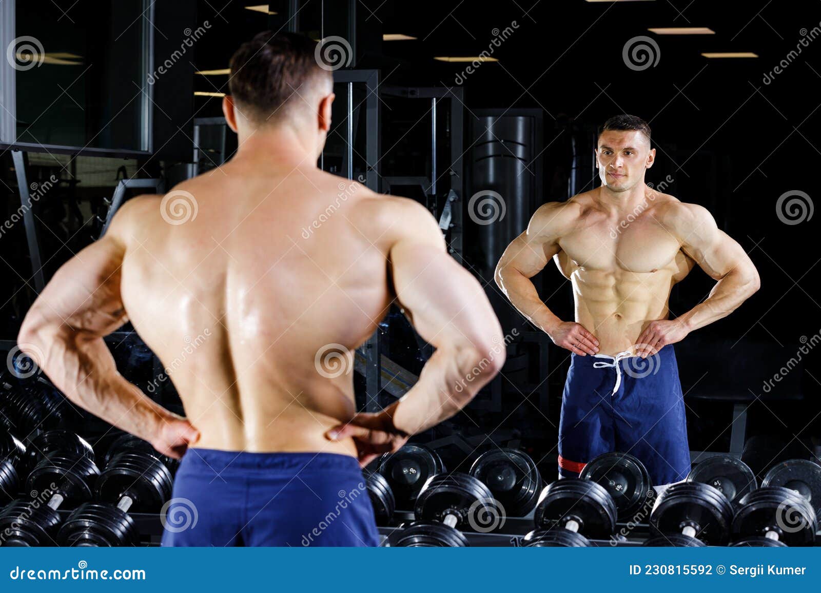 The sportsman pose in front of the mirror in the gym Stock Photo | Adobe  Stock