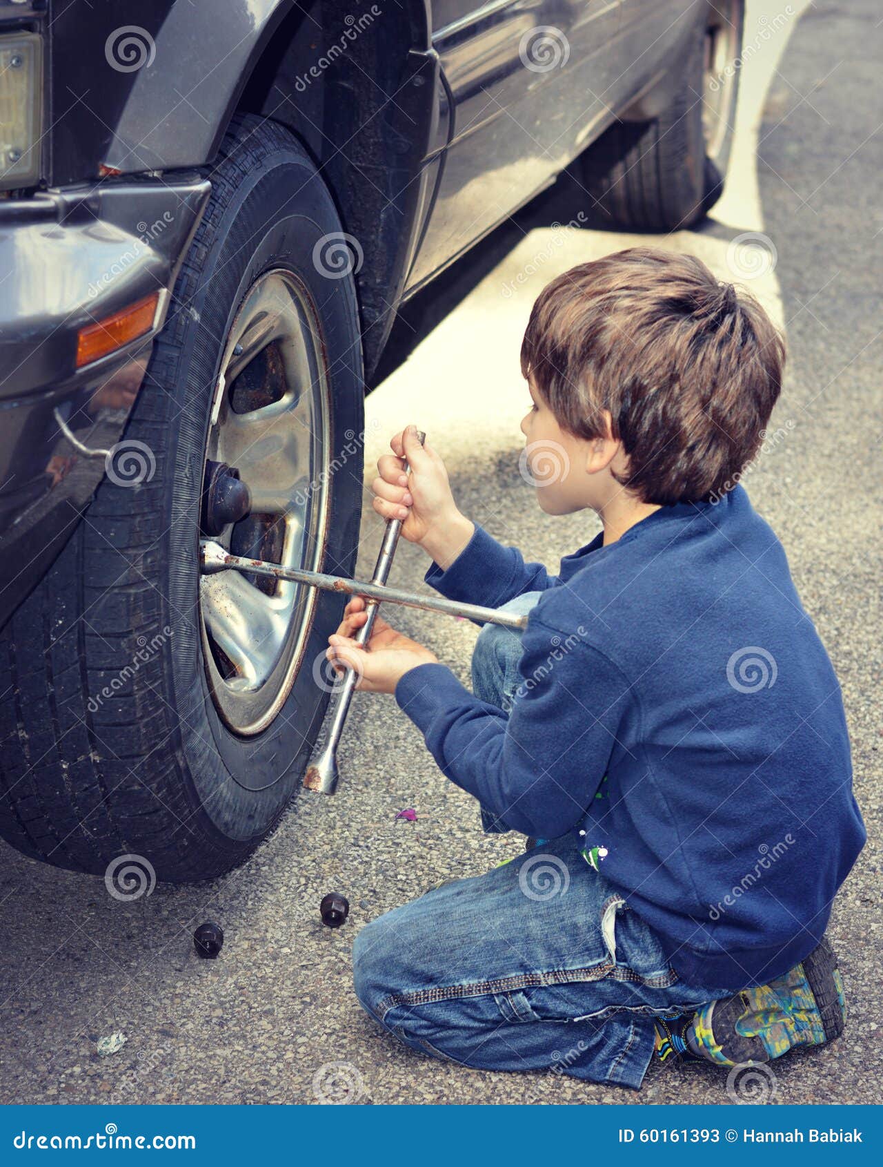 Young Boy Changing Tire stock image. Image of helping 60161393